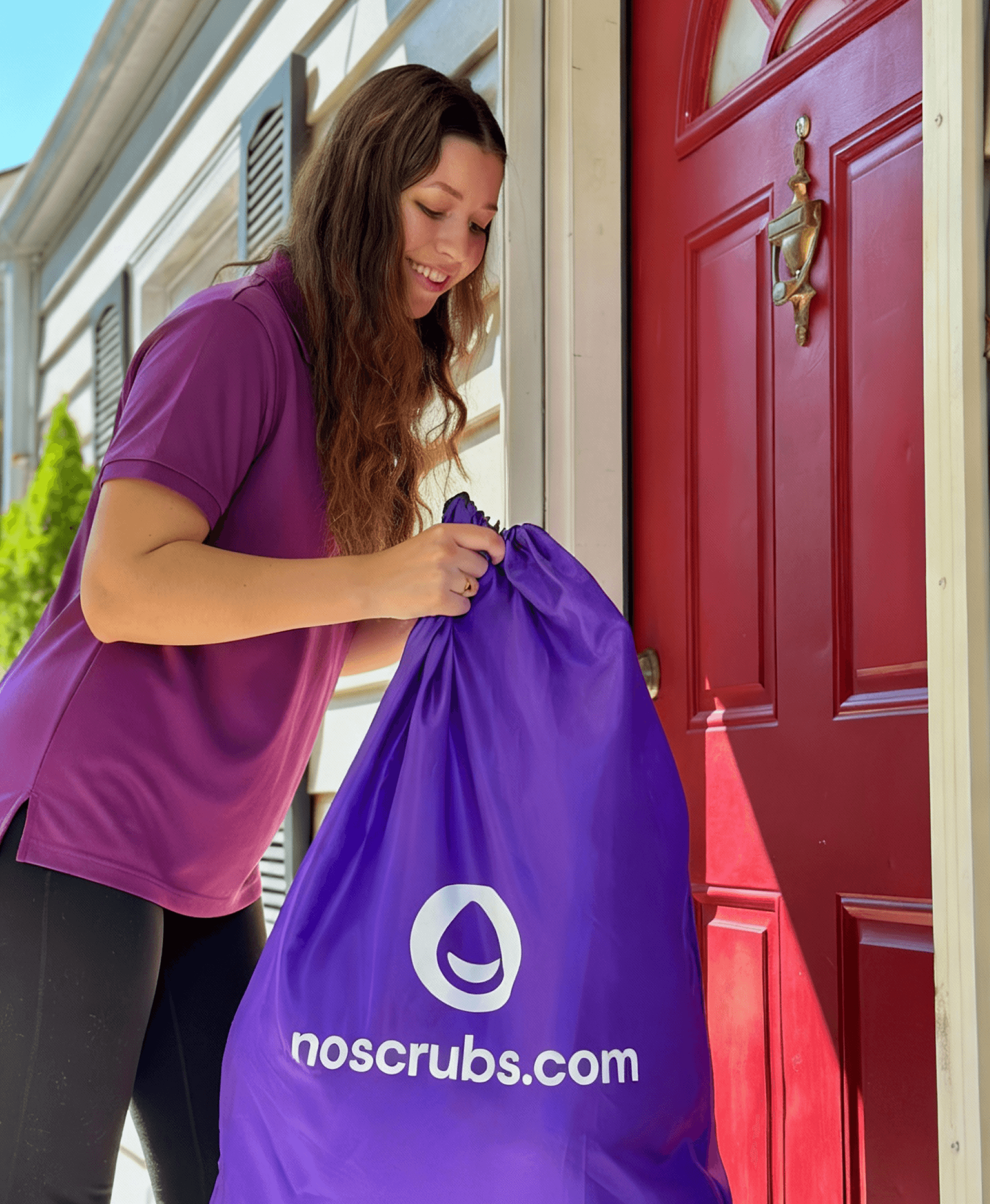 A NoScrubs Scrubber picking up a laundry bag from the doorstep.
