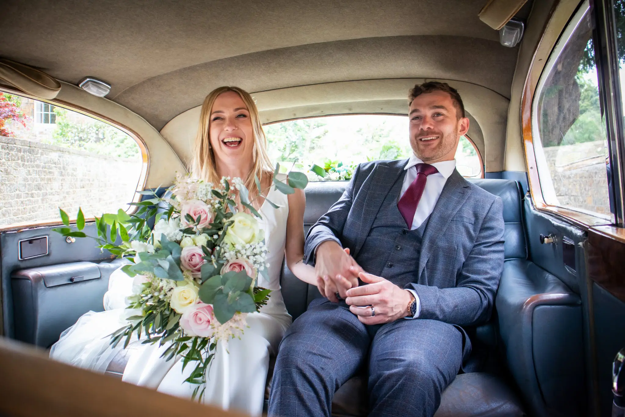 newly married wedding couple in wedding car