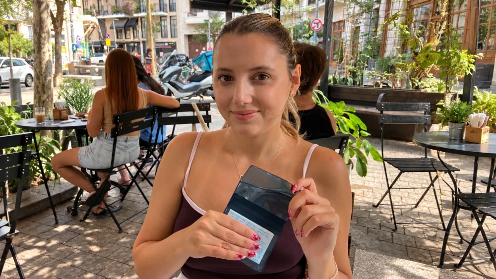 Turku Avci holds her Israeli ID in Tel Aviv on Oct. 11, 2026, after she was granted asylum. Photo courtesy of Etgar Lefkovits.