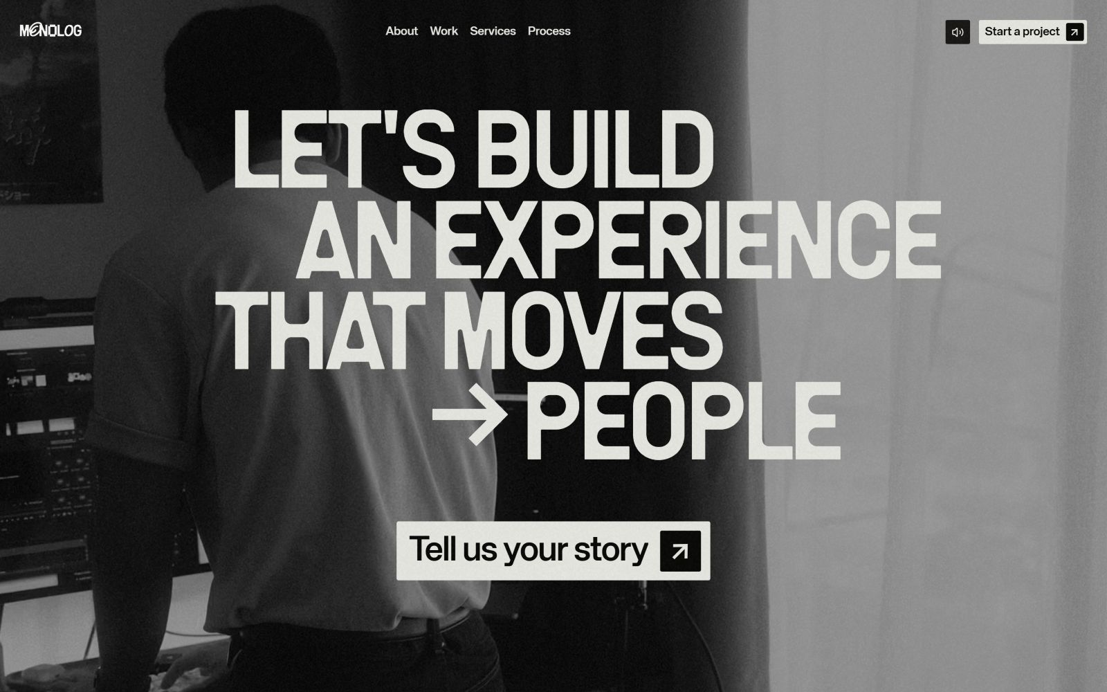 Black and white website with large text: "LET'S BUILD AN EXPERIENCE THAT MOVES → PEOPLE" and button "Tell us your story".