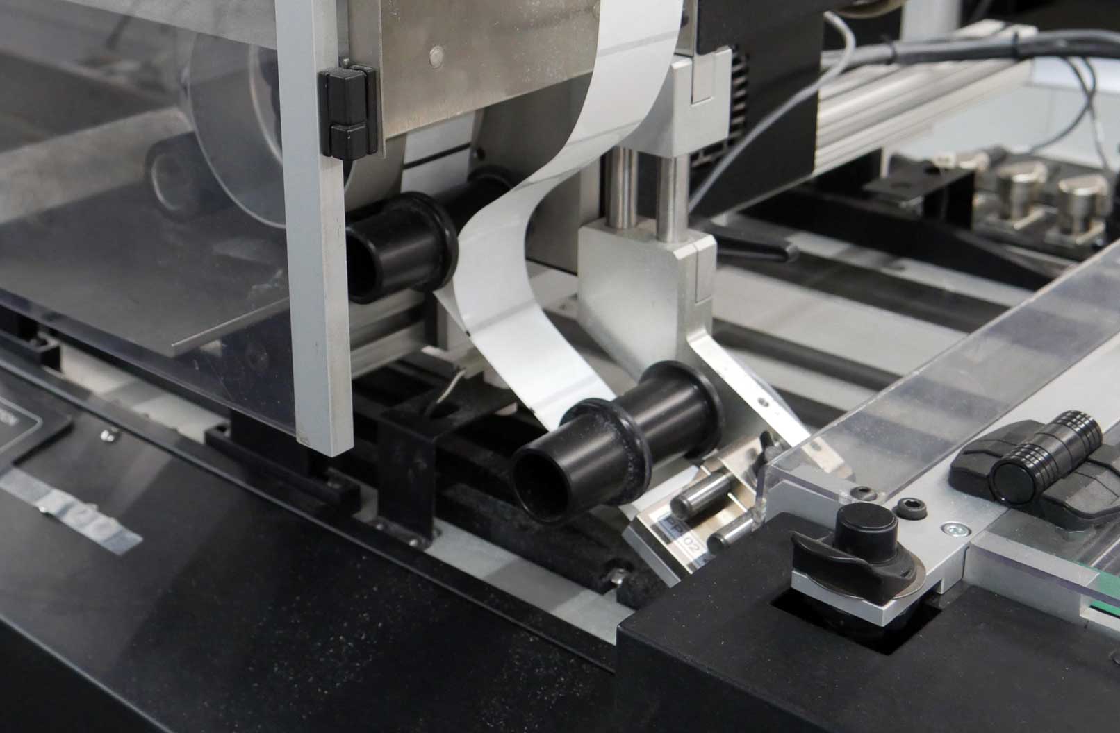 Closeup photo of a stamp application machine