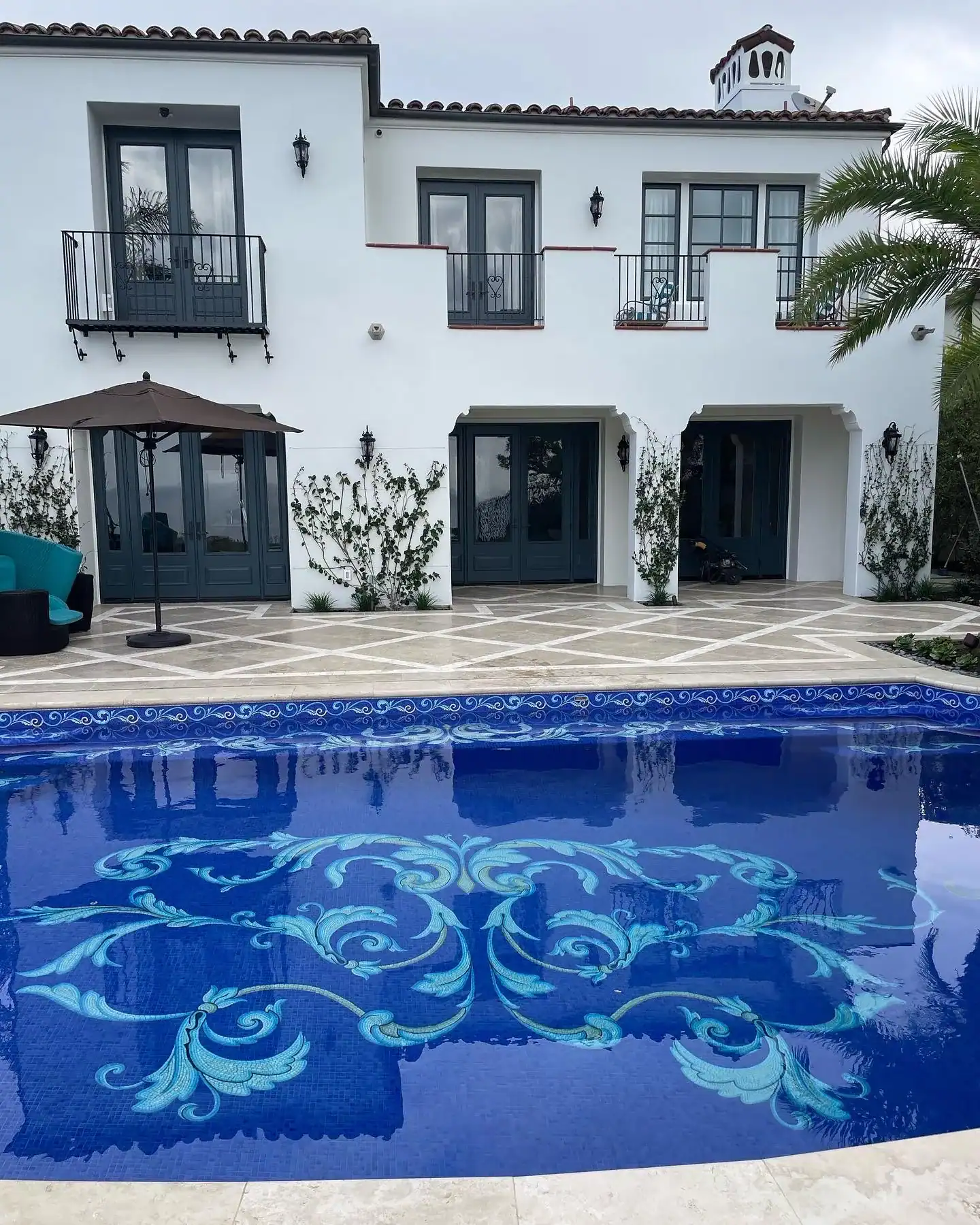 Custom mosaic waterline border for luxurious swimming pools.