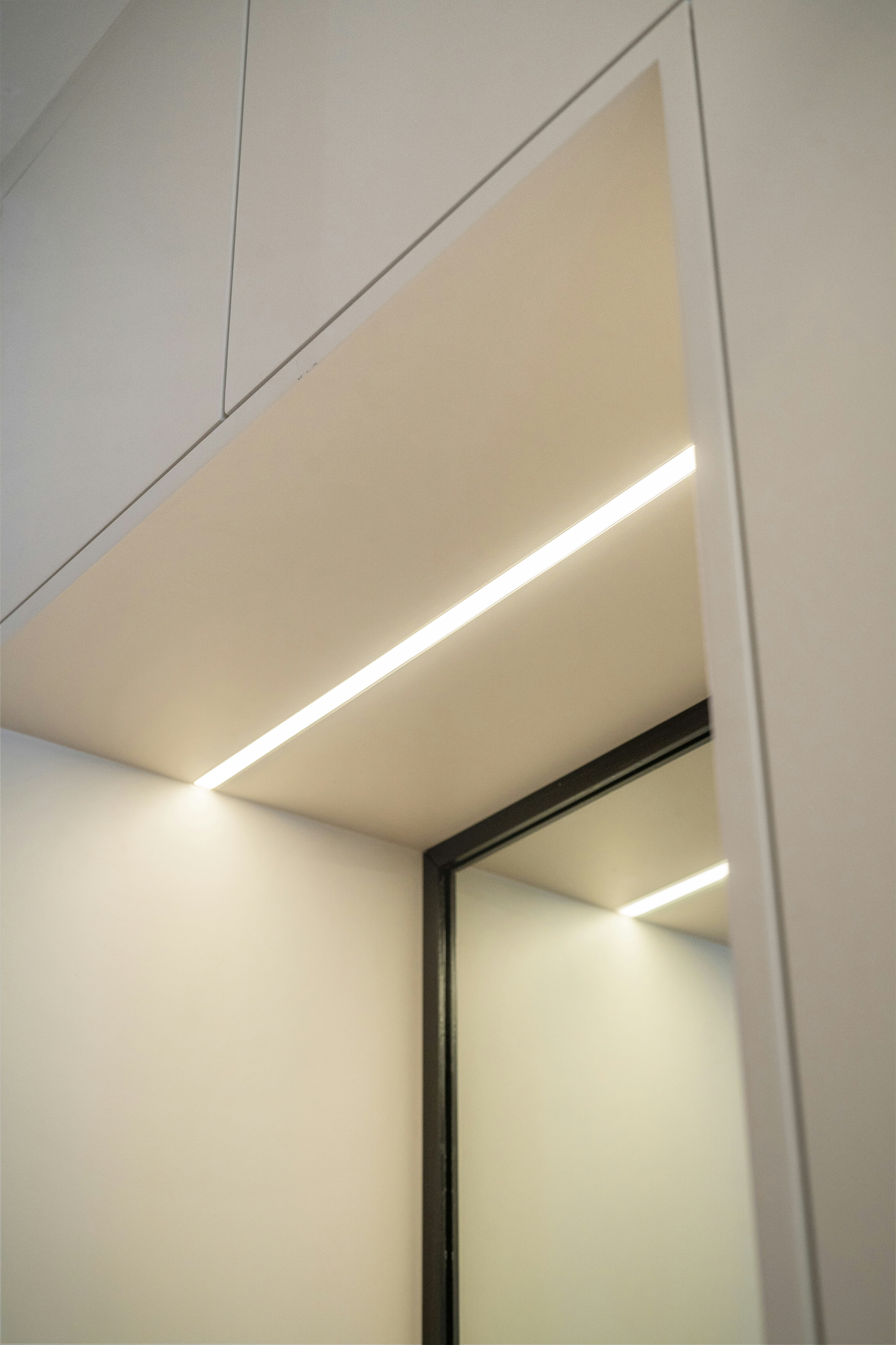 A white room with a mirror and lights