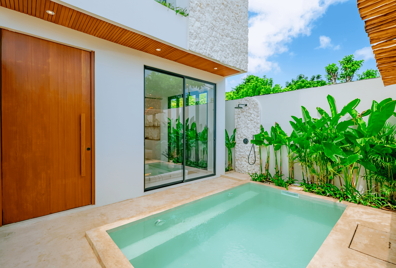 Tropical private pool and garden view of a modern Bali villa, a top choice for real estate investment.