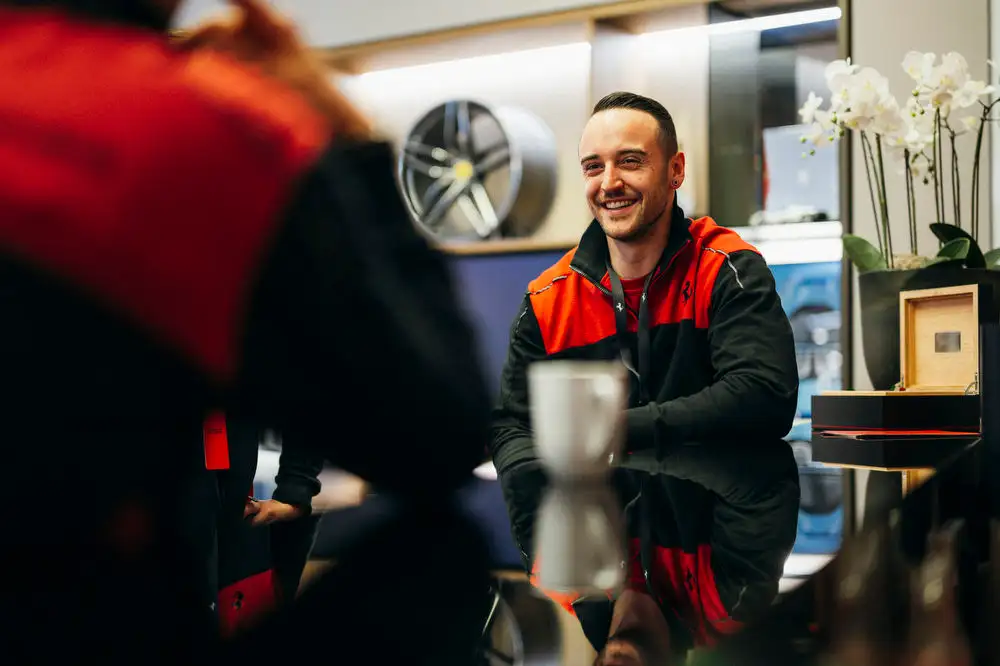 Team member of Autohaus Gohm laughing and speaking to colleagues