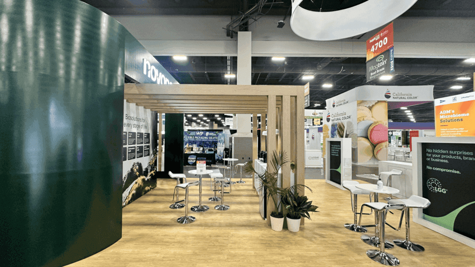 20x30 ingredient booth with product application displays, buyer conversation space, branded graphics, and visitor flow