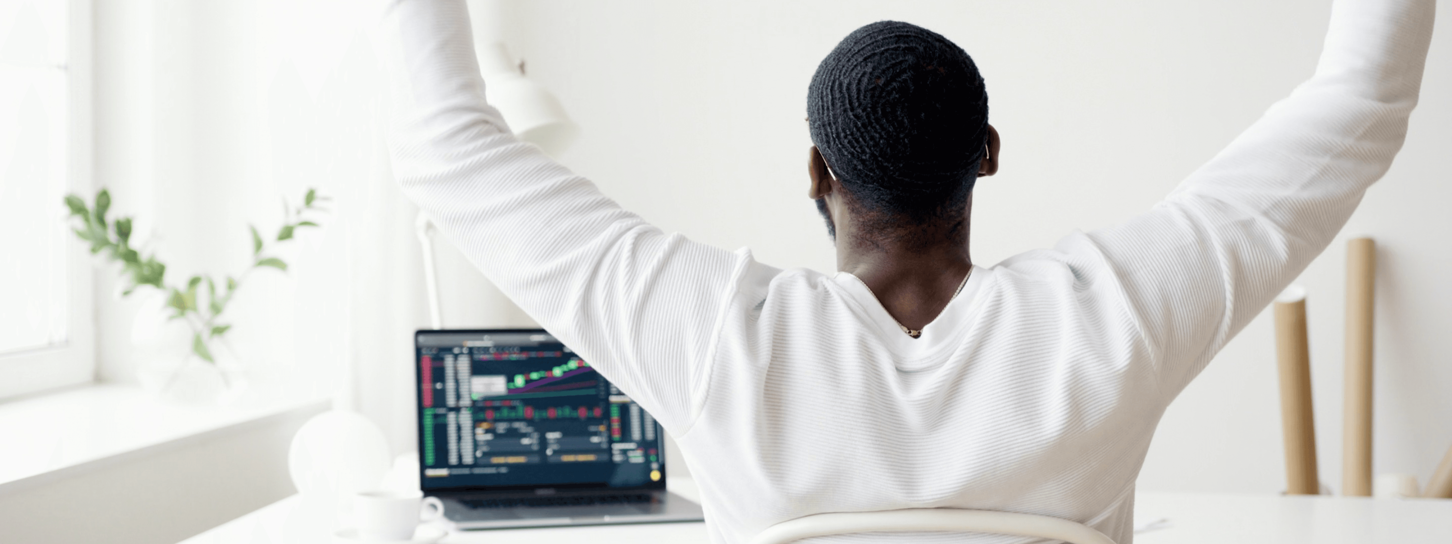 Photo of a West African business man celebrating in front of his laptop. Photo by Anna Nekrashevich.