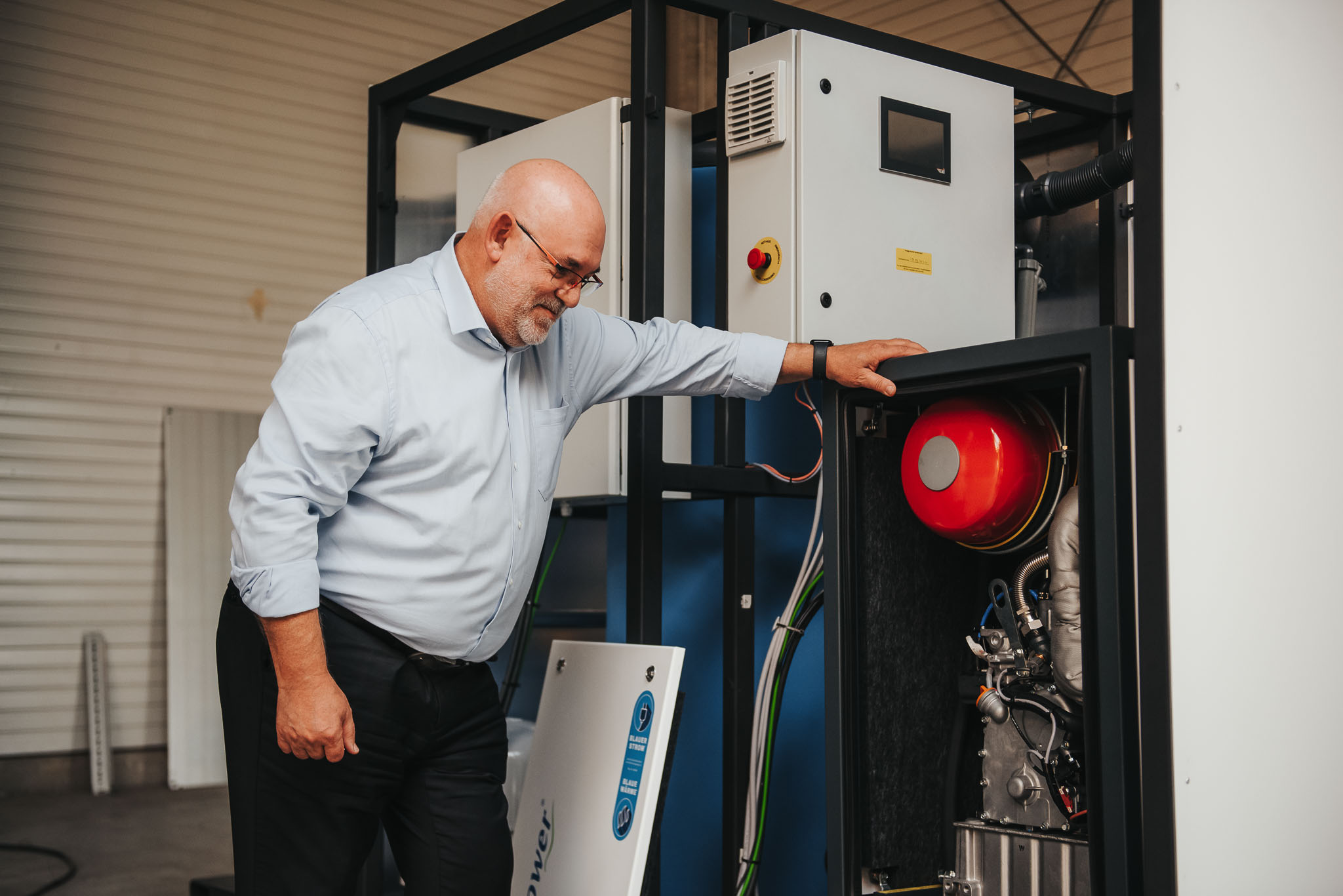Shiny metallic silver foil pouch lying flat, printed with a large black outline of a smiley face, all set against a bright orange backdrop.