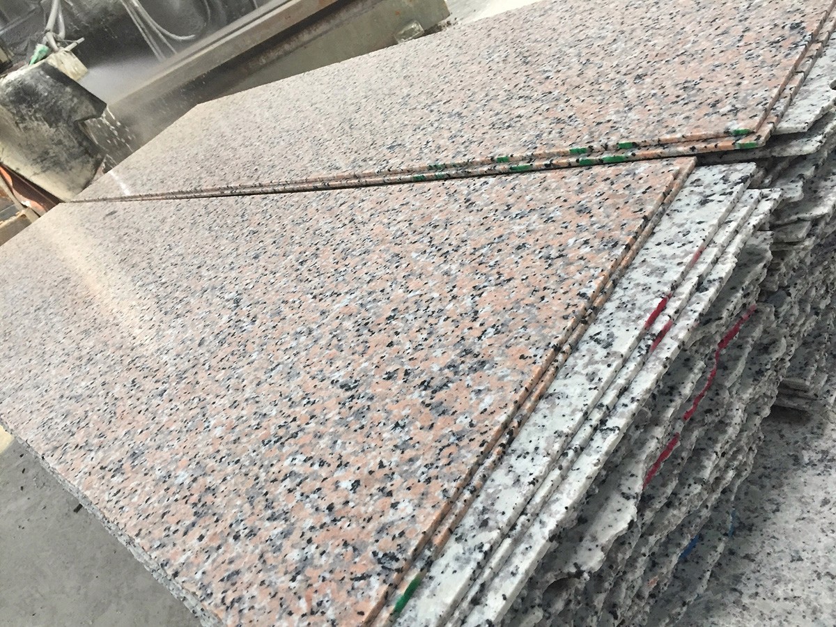 A stack of polished granite slabs, ready for shipment, illustrating the Manual Polishing Machine's productivity and consistent quality.