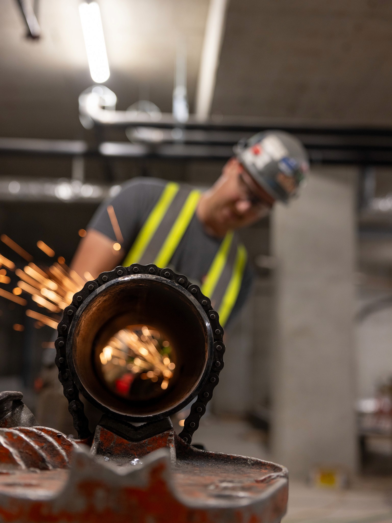 Chilliwack plumber working with pipe and sparks in the Chilliwack Andmar Development in British Columbia for HVAC and plumbing.