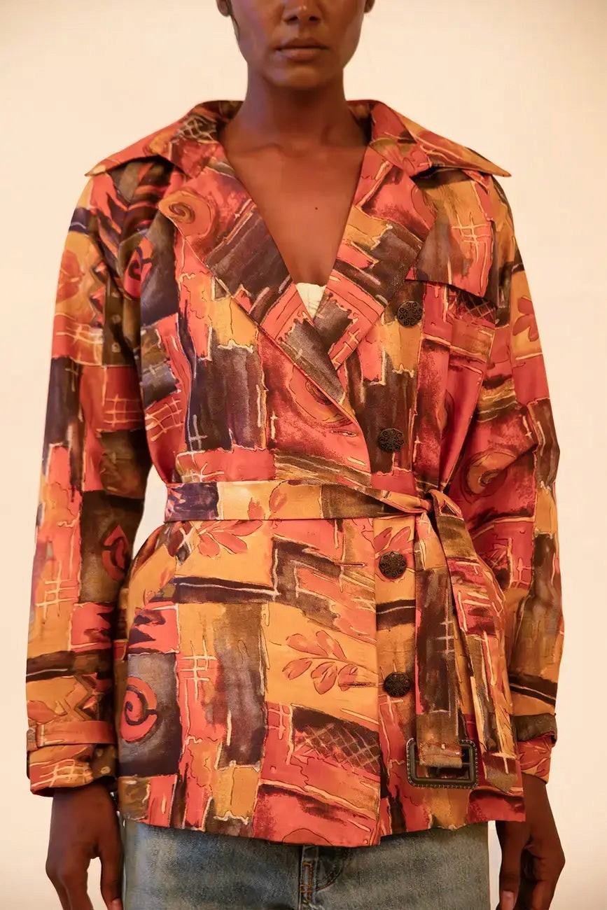 Cropped trench coat crafted from upcycled abstract print silk, featuring a relaxed fit and lightweight structure.