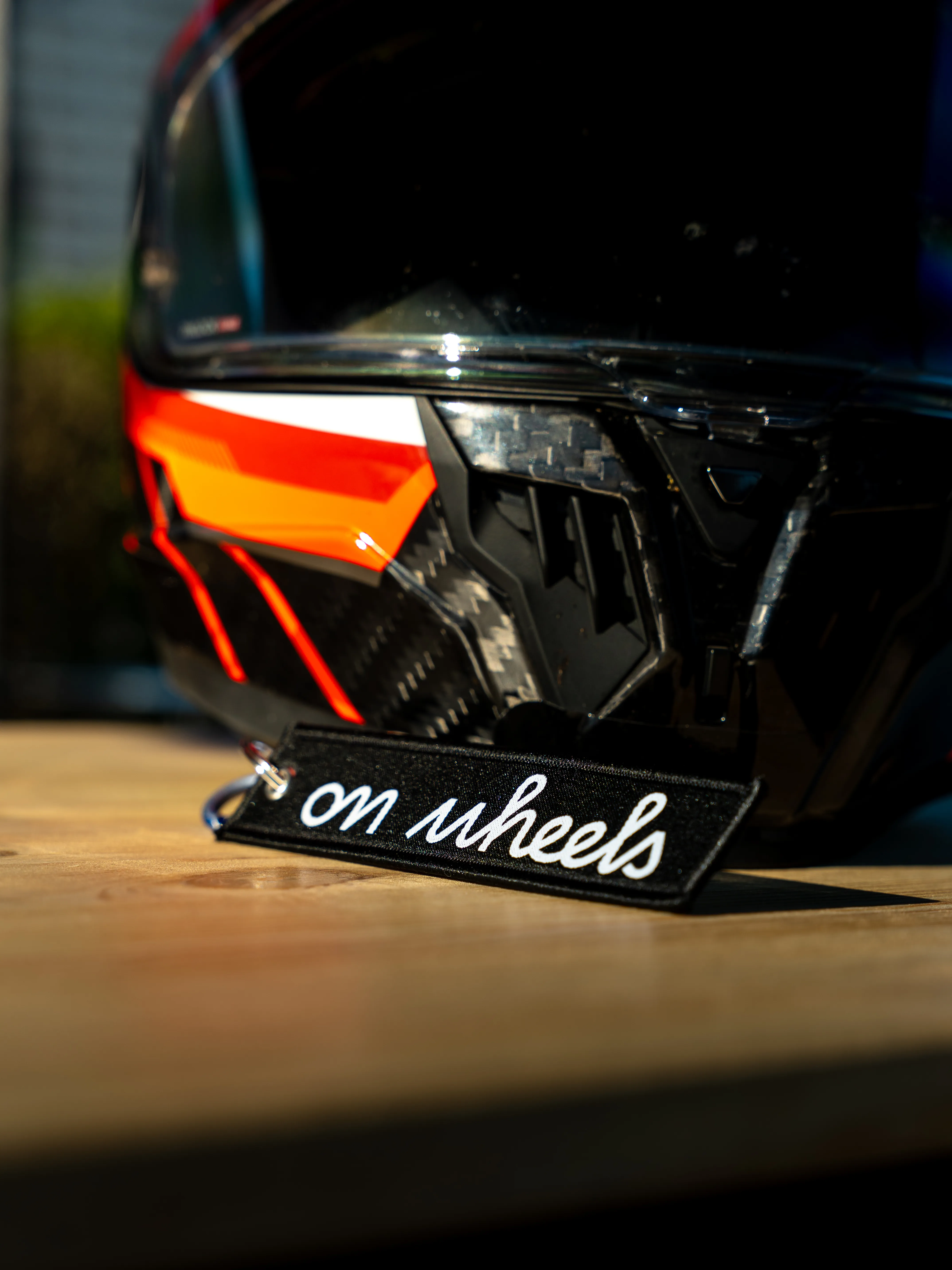 Porte-clés On Wheels accroché à un jean avec mousqueton, accessoire motard du quotidien