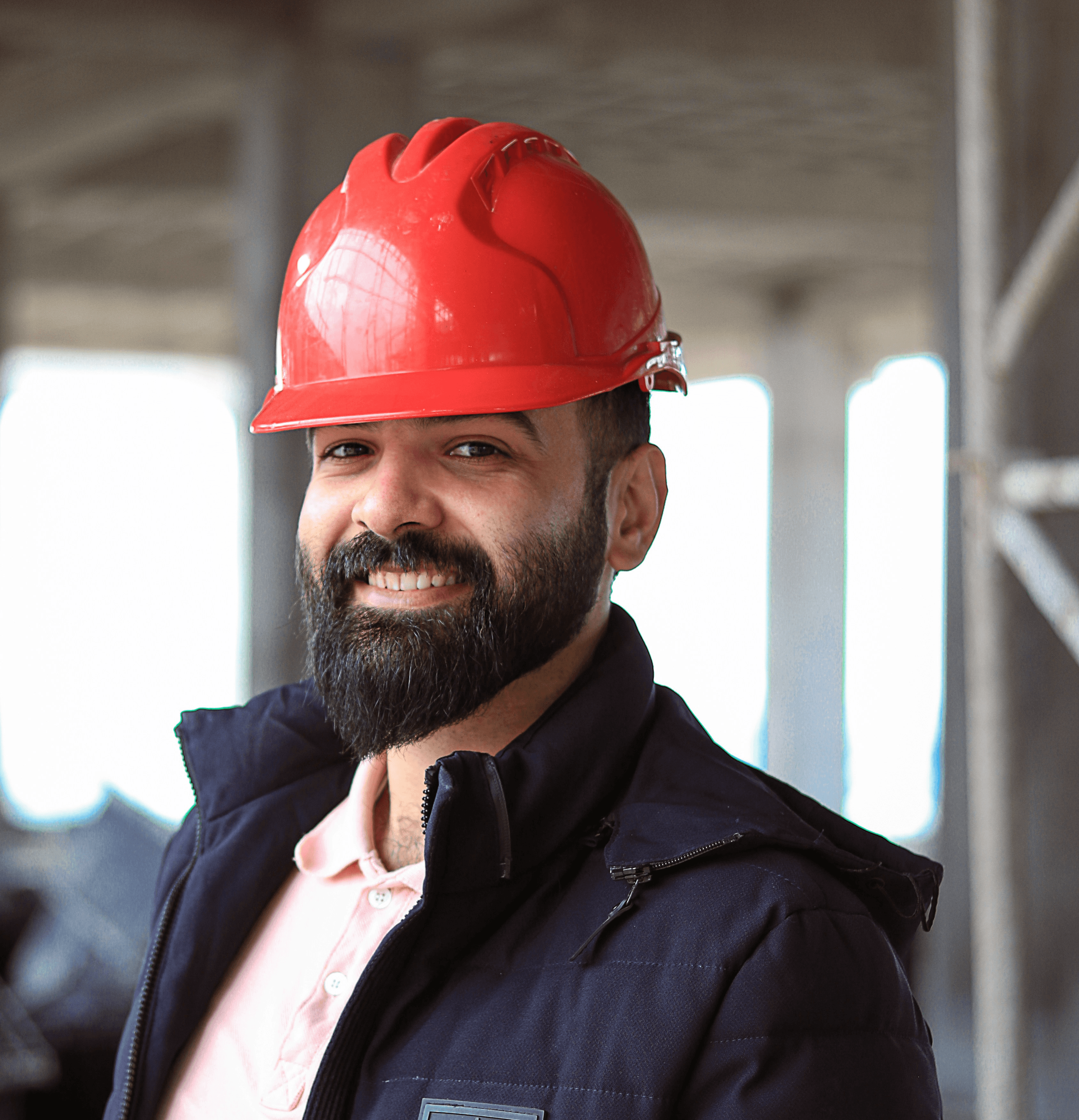 a man wearing a red hard hat and jacket