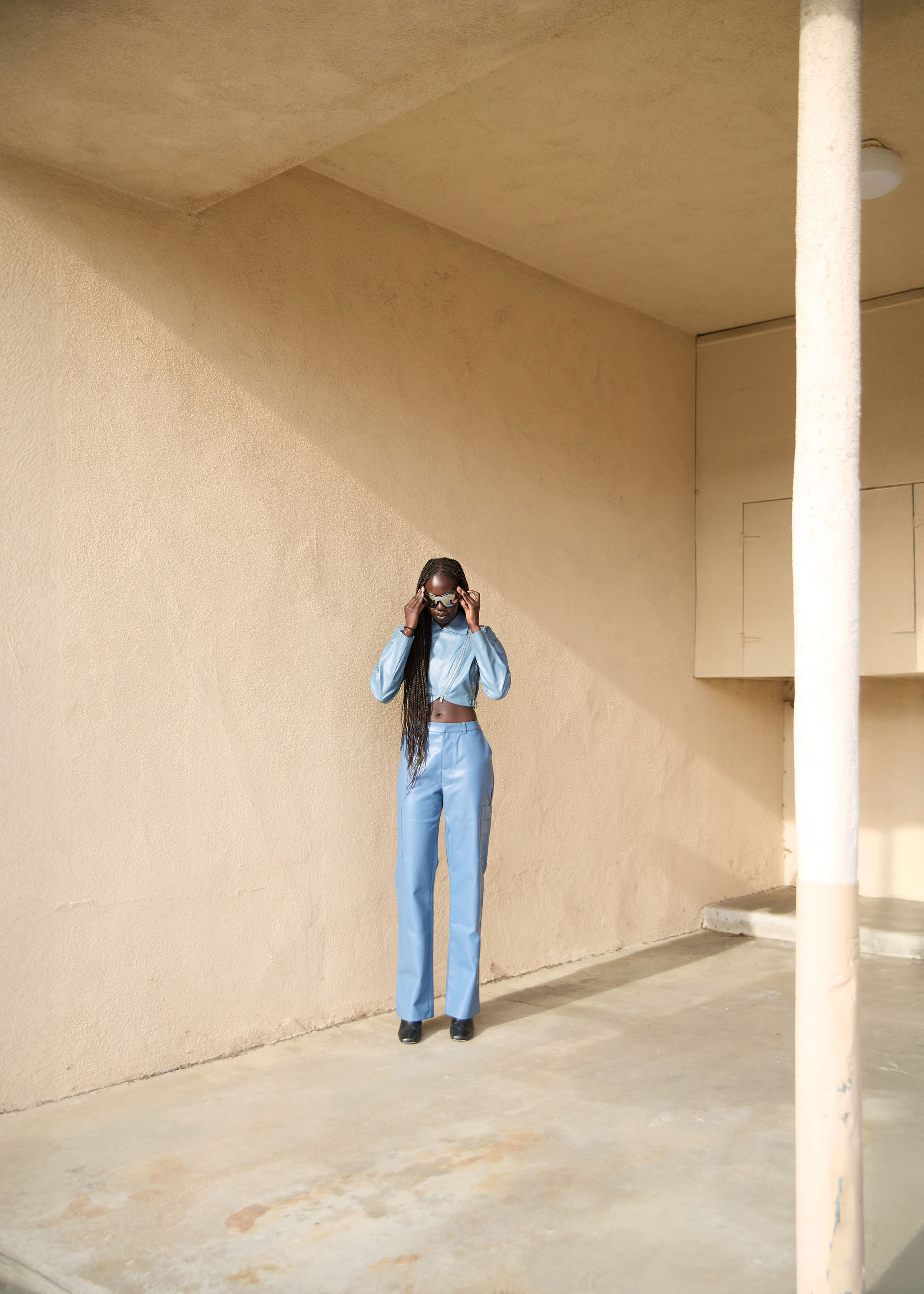 Woman walking on a curved pavement with shadow.