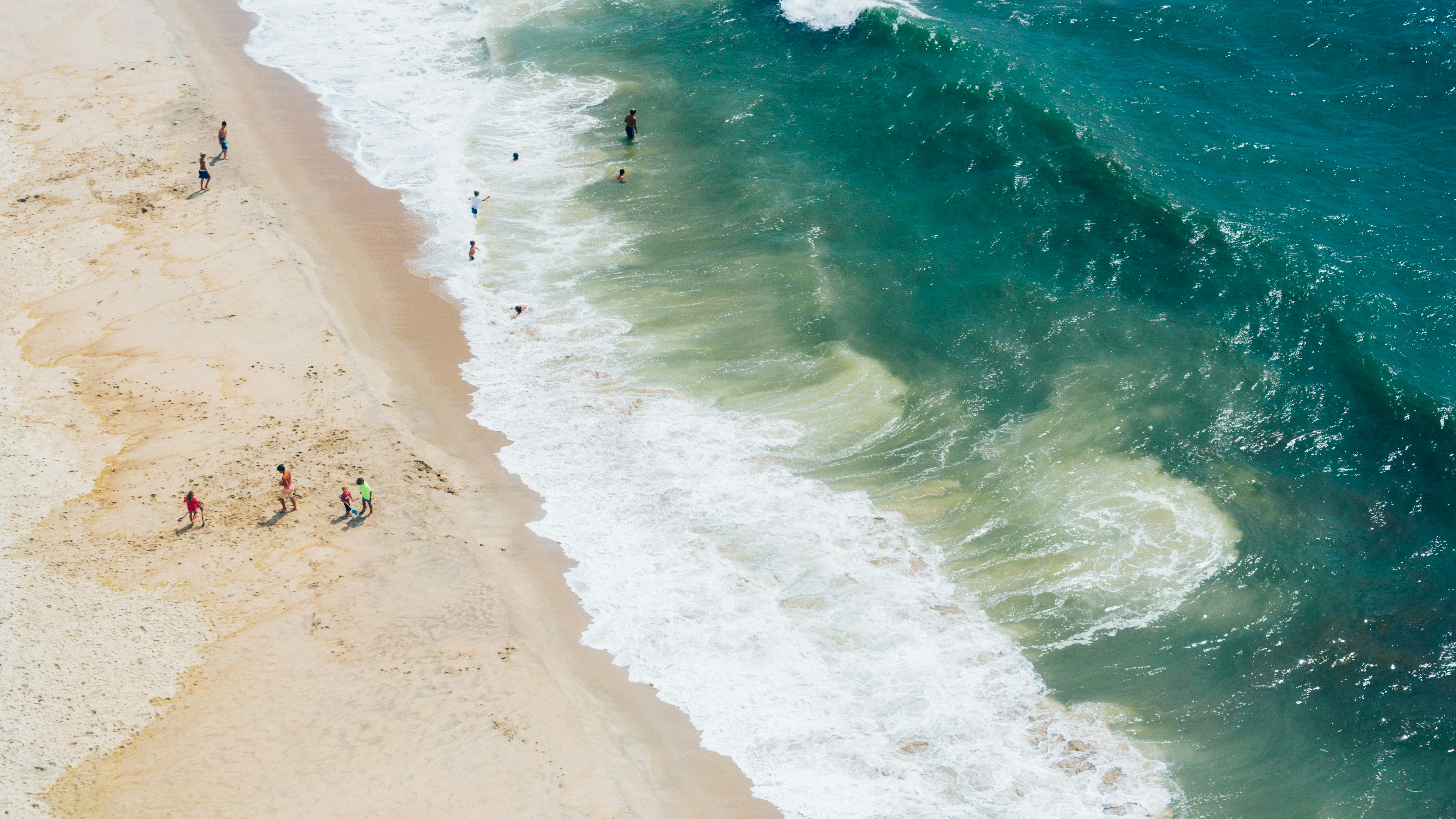 aerial photography of people near shore