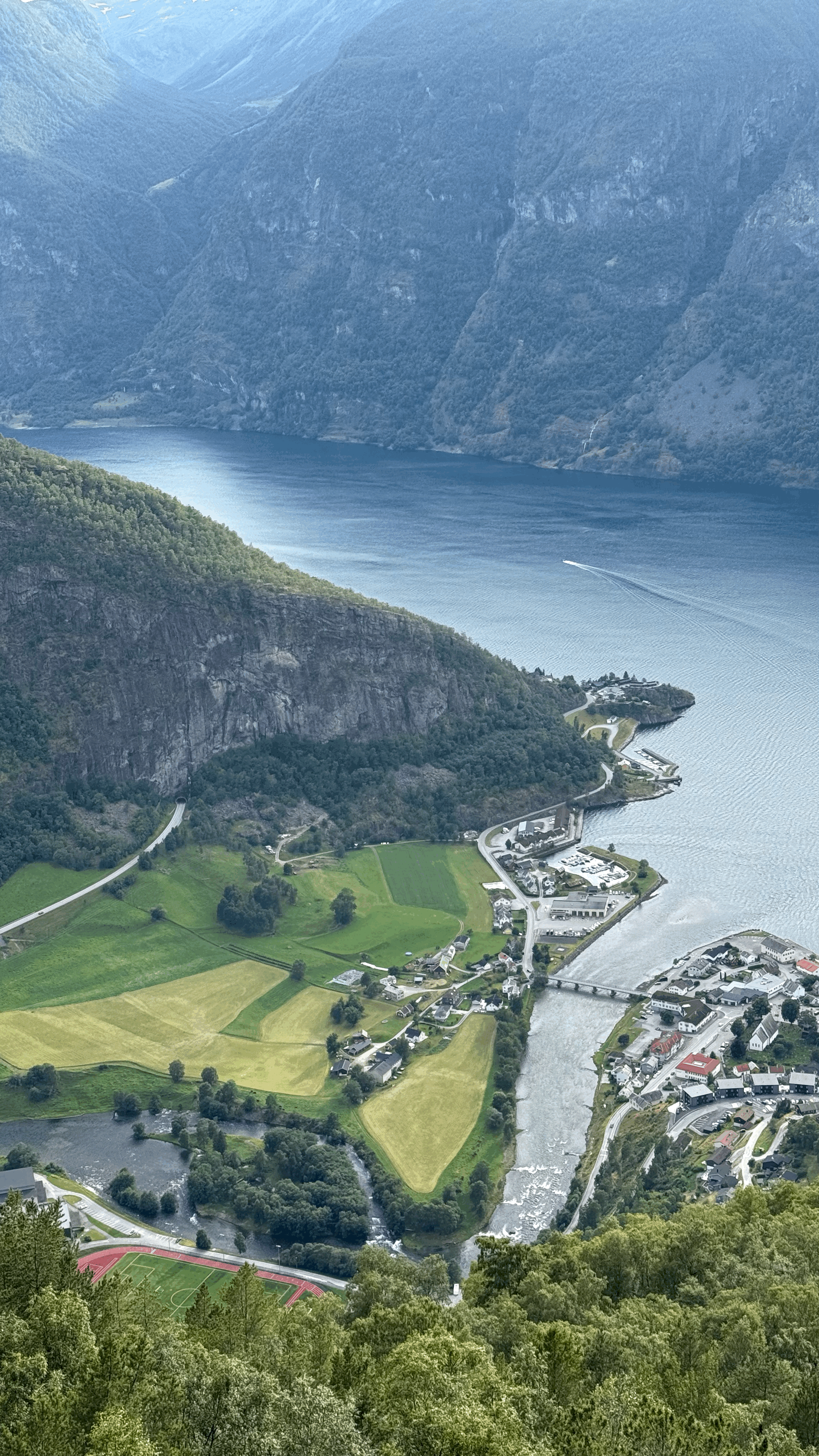 a boat in a body of water surrounded by mountains