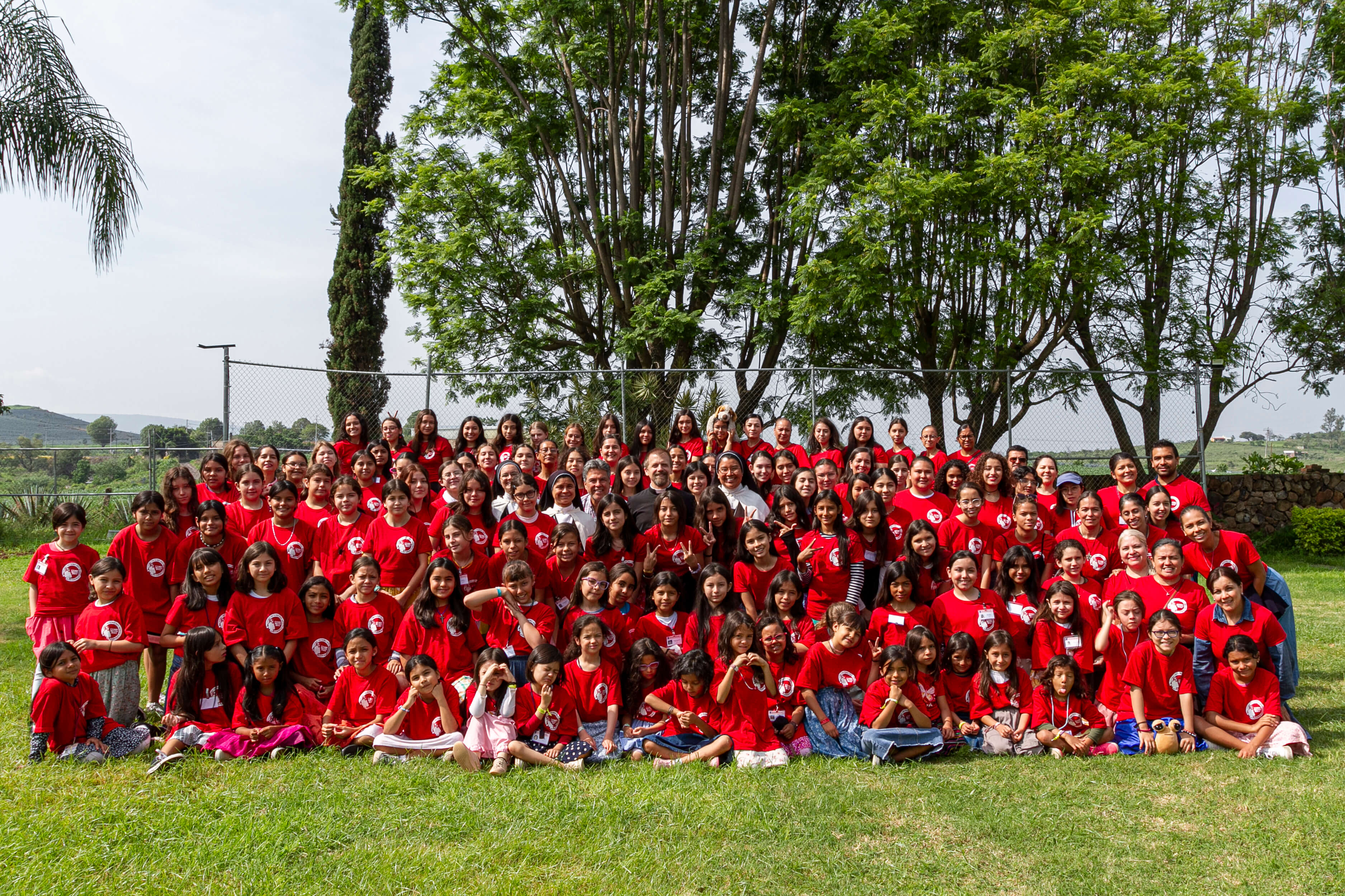 a group of children sitting on steps in front of a building