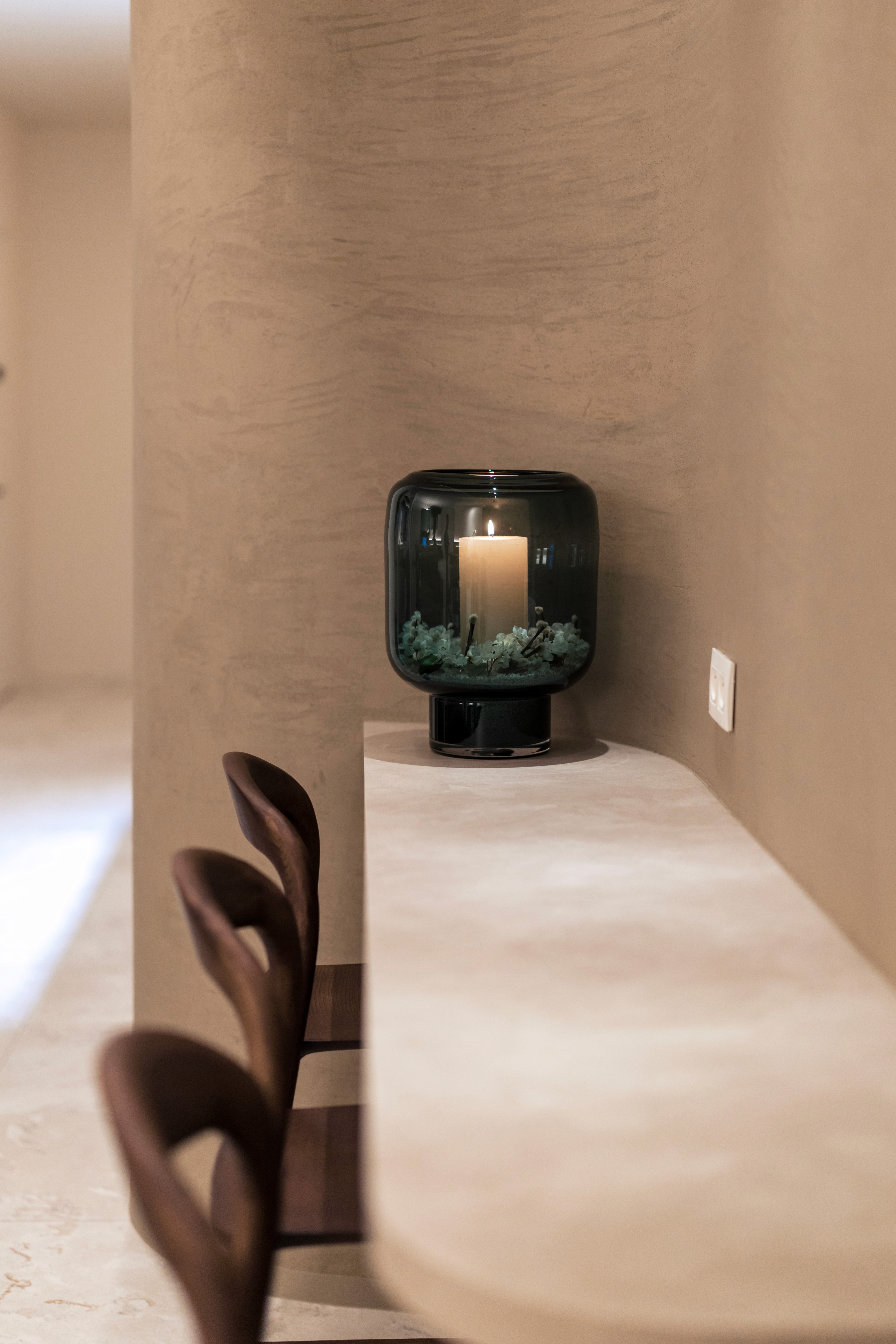 Portrait of a woman with short brown hair, eyes closed, gently holding her face