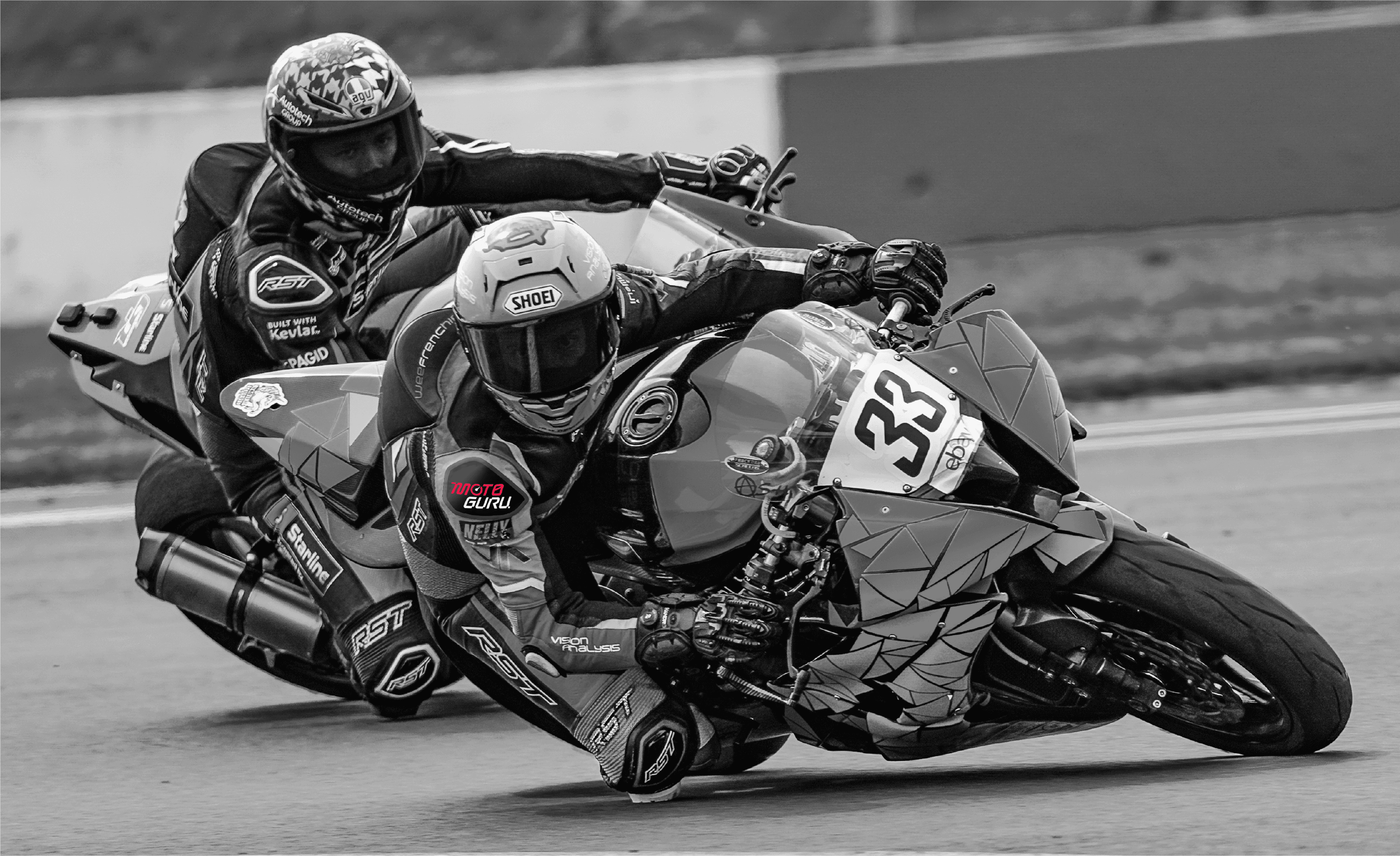 Black and white image of two motorbikes racing