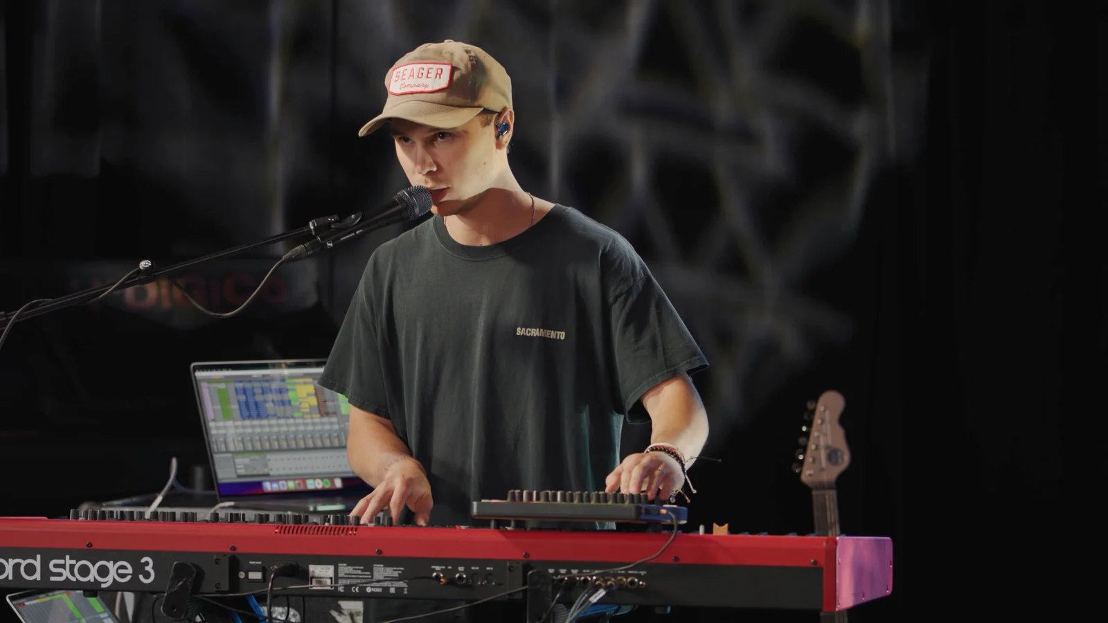 A keyboard player putting practical training into action during worship rehearsal.