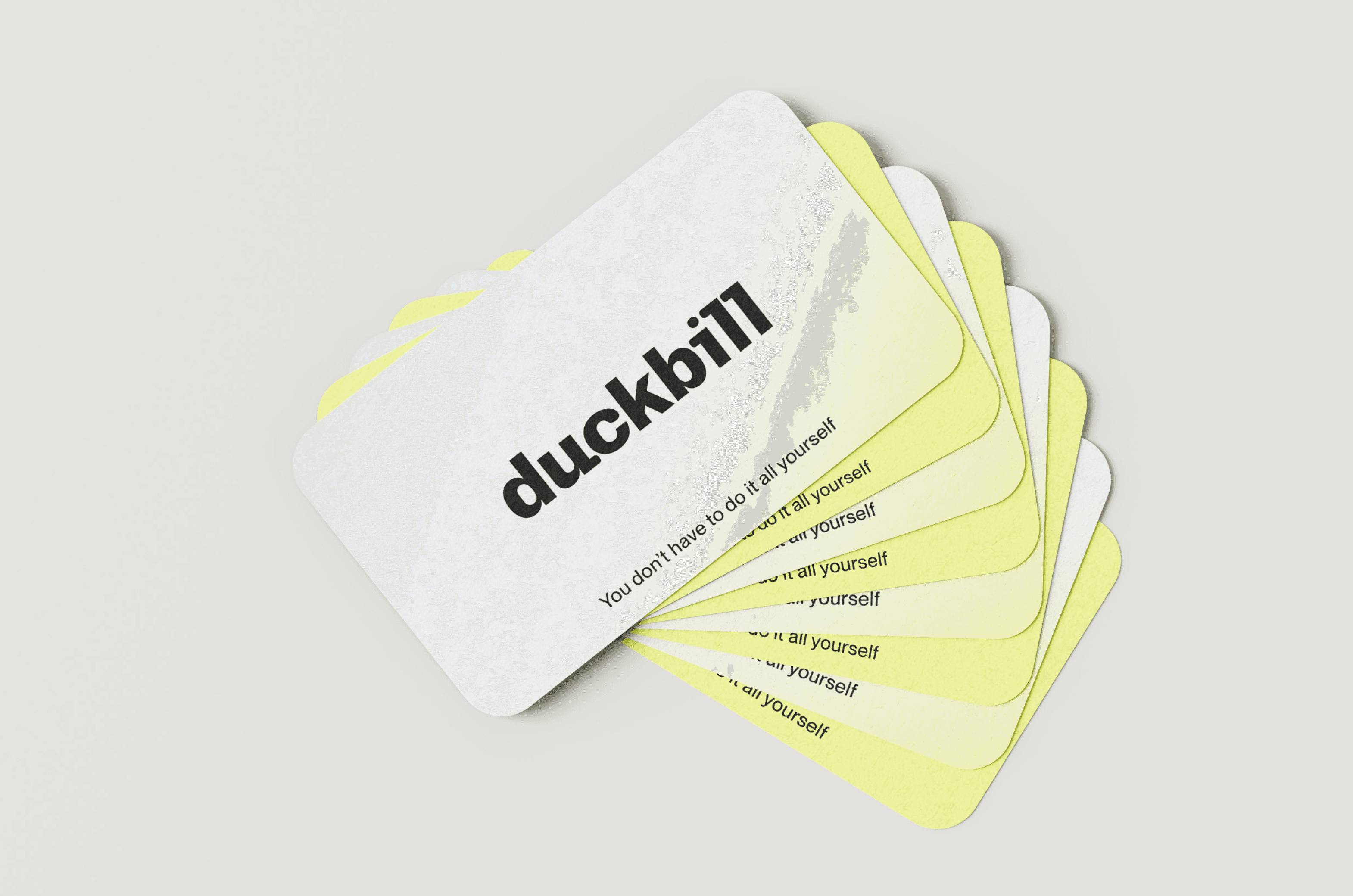 A stack of Duckbill cards fanned out, featuring the phrase "You don't have to do it all yourself" on each card, with alternating white and yellow backgrounds.