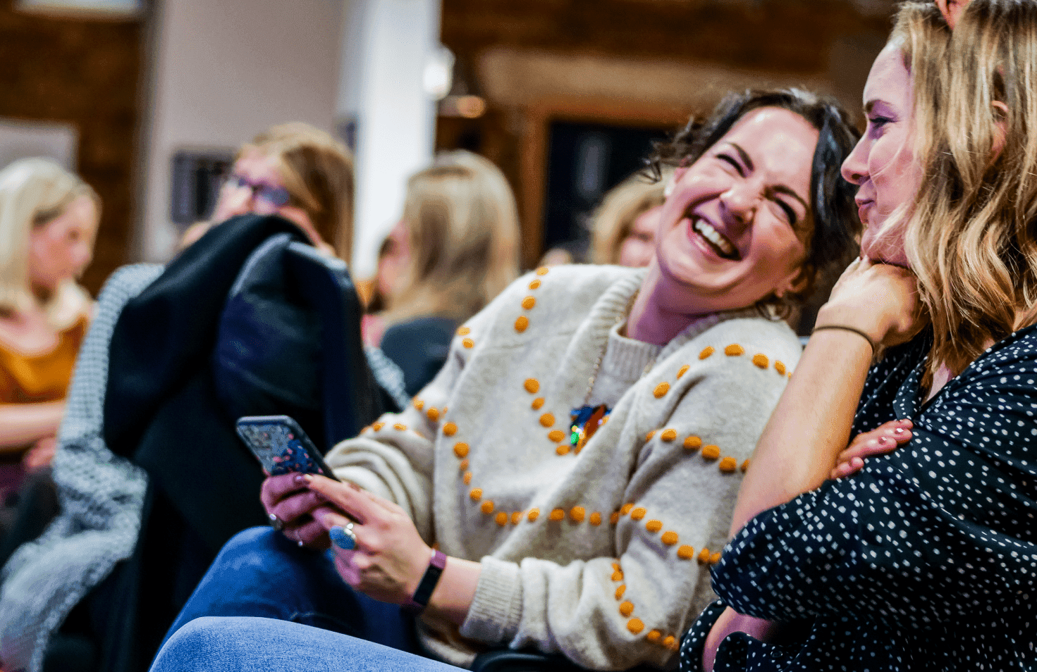 People sitting and smiling, laughing.