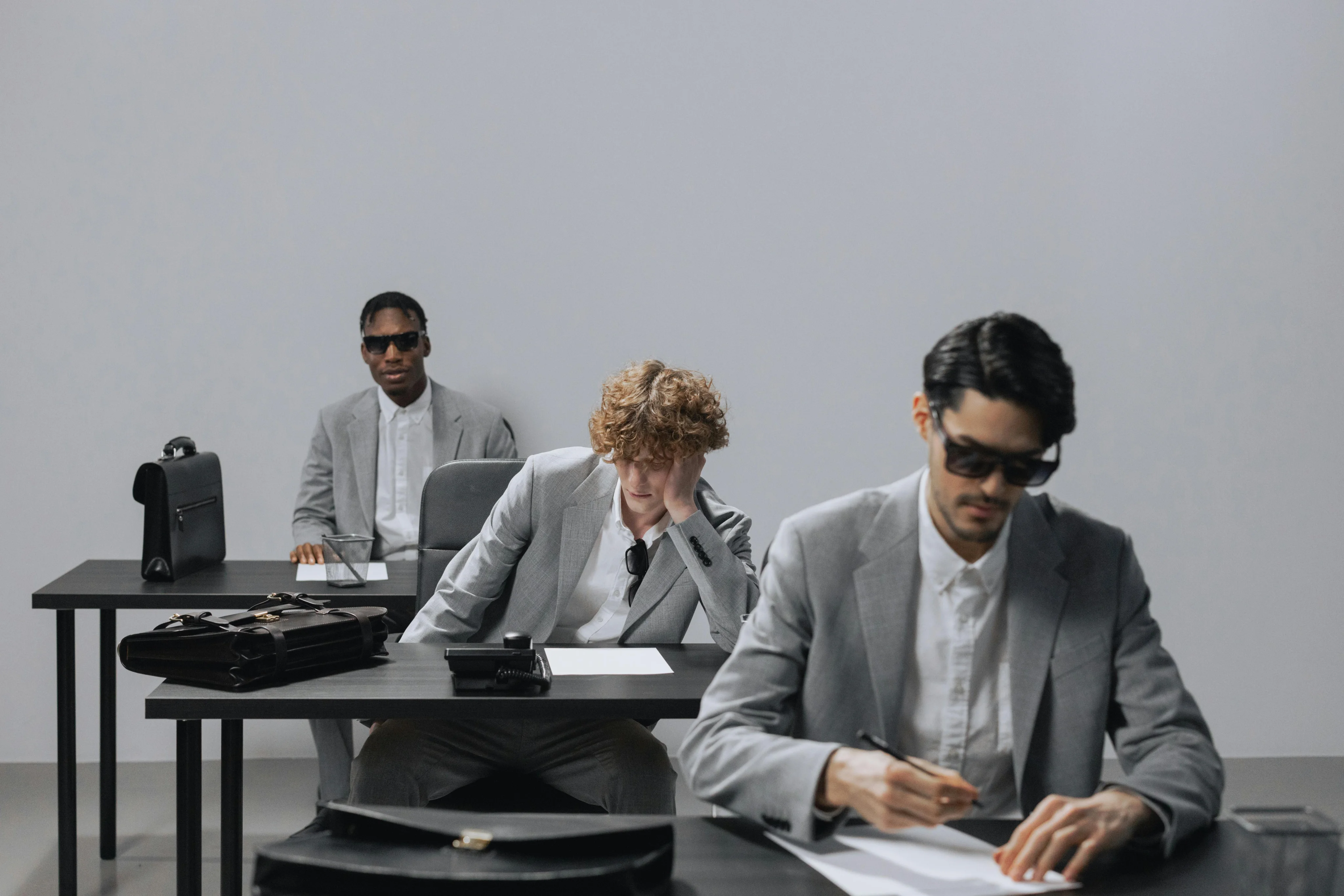 James Carter, Ethan Brooks & Chris Ford are sitting on desk