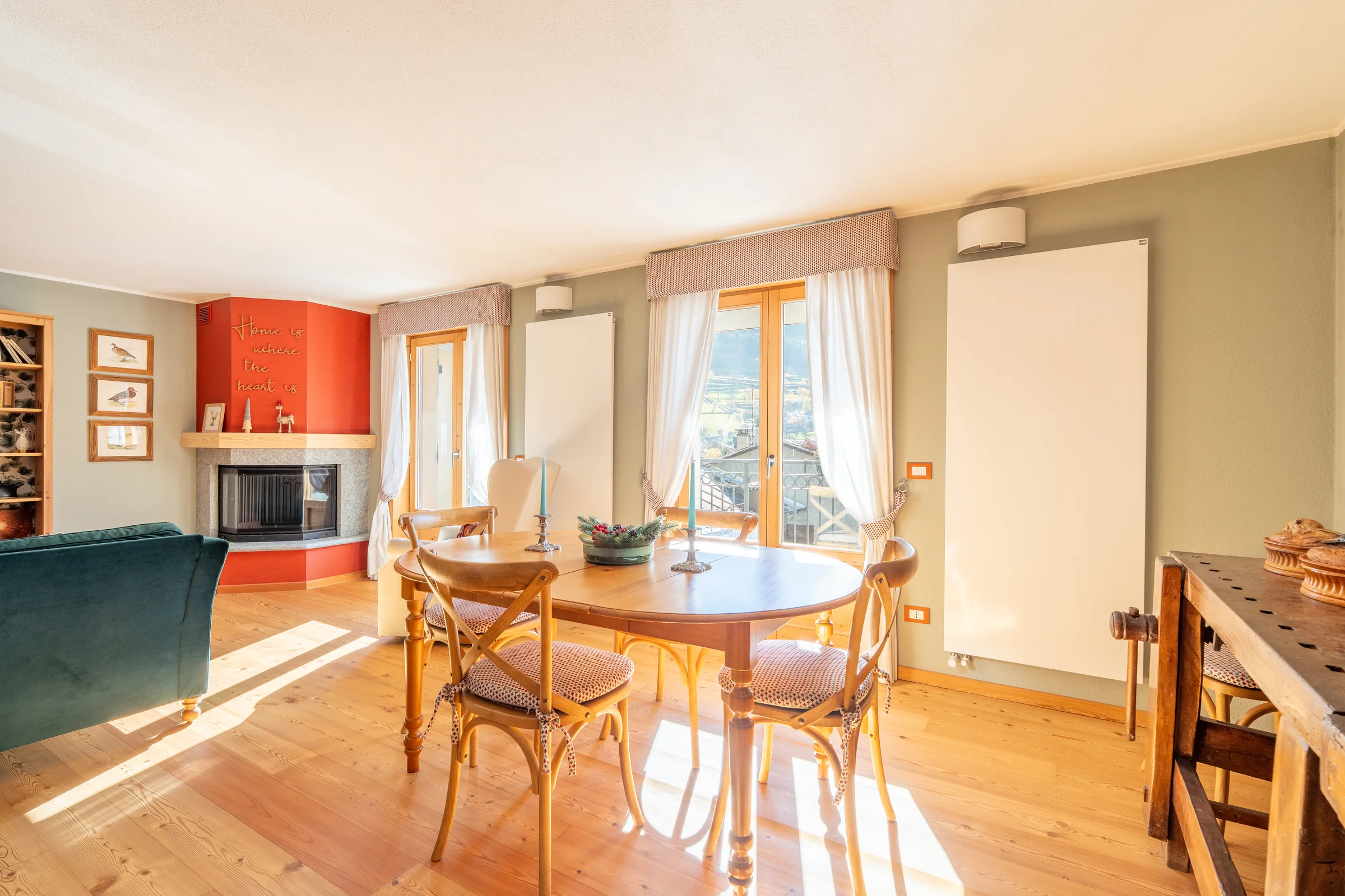 Sunlit living and dining room with wood finishes — Bormio & Valtellina, Italy. Photography by Yunes Calore.