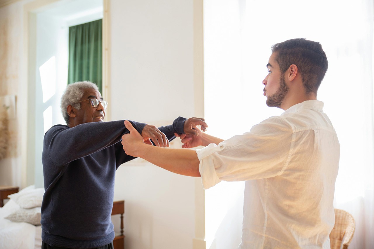 elderly man with a personal fitness instructor at home