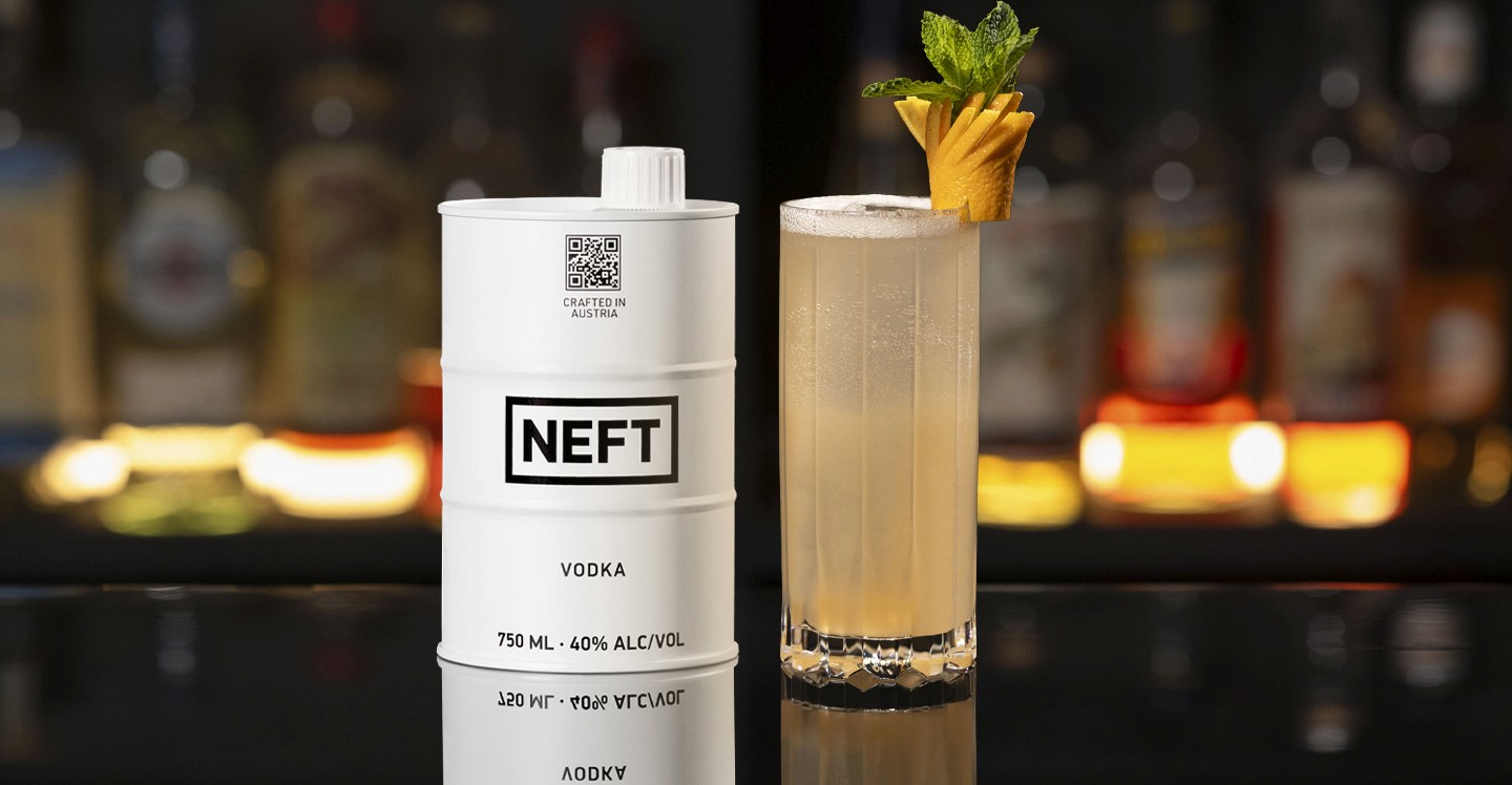 A NEFT Barrel and a glass of Miami Spritz on a bar counter.