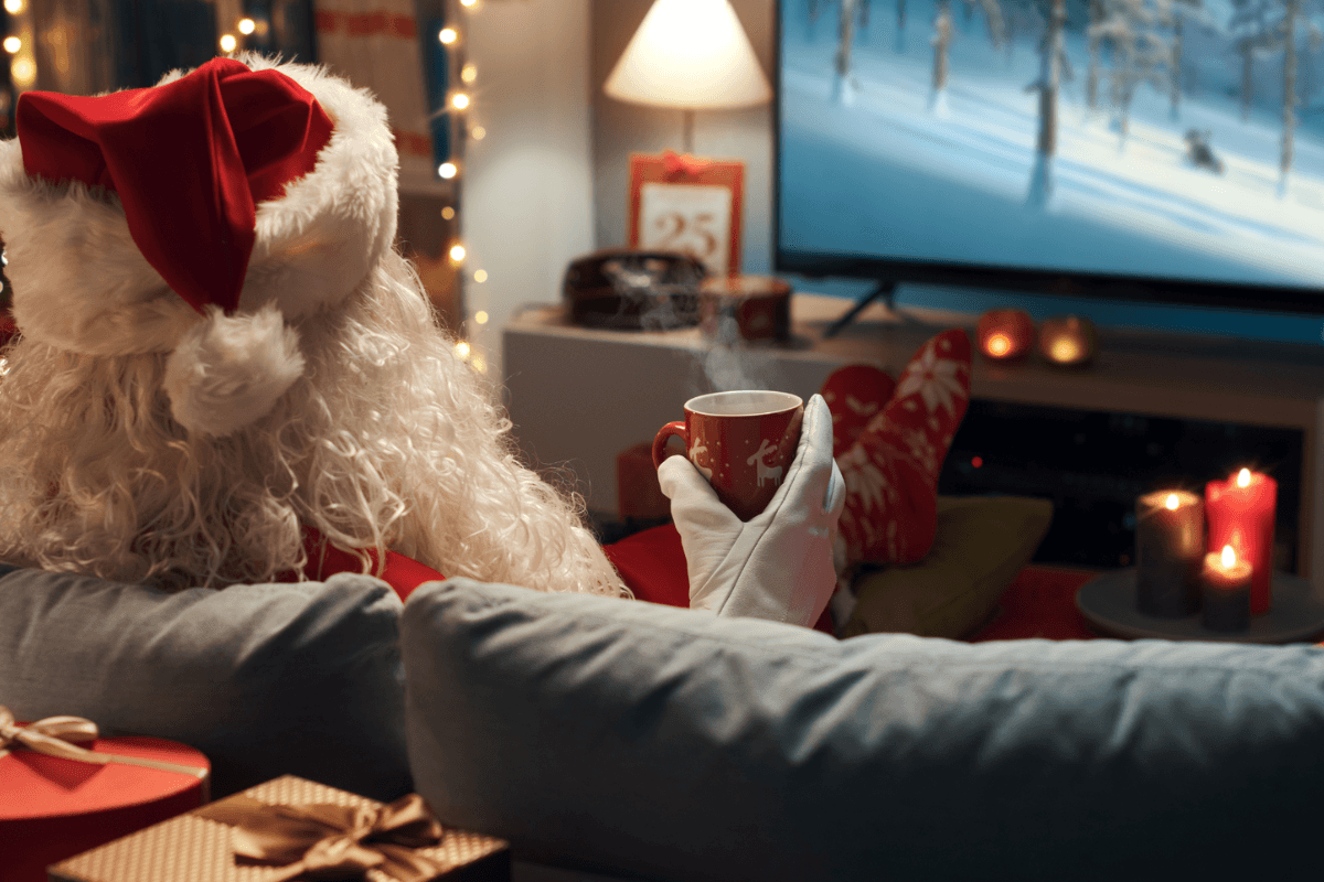 Burglar in Home Dressed as Santa Claus Relaxing and Having a Hot chocolate