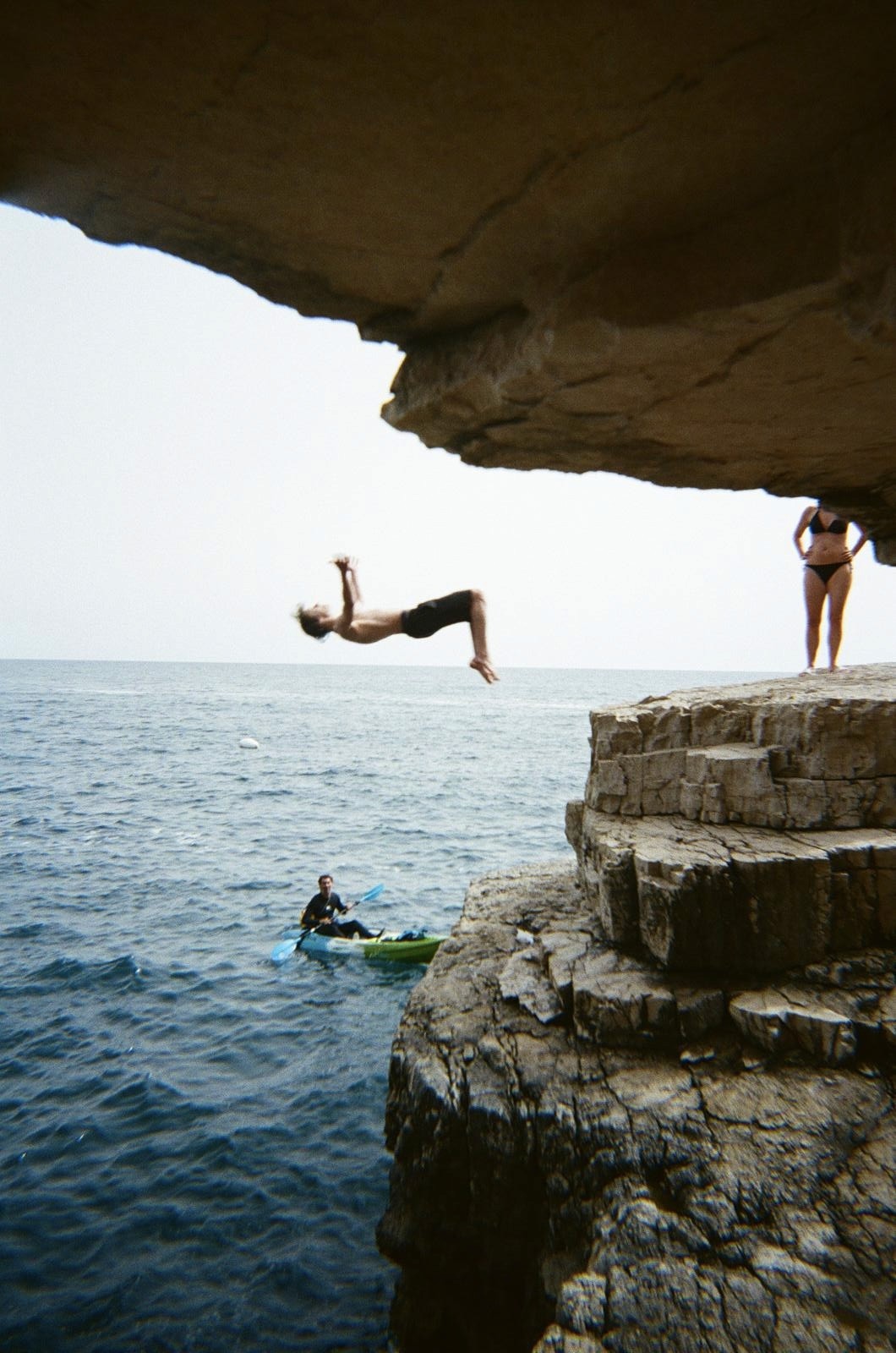 Group of friends smiling on a lively city street at night