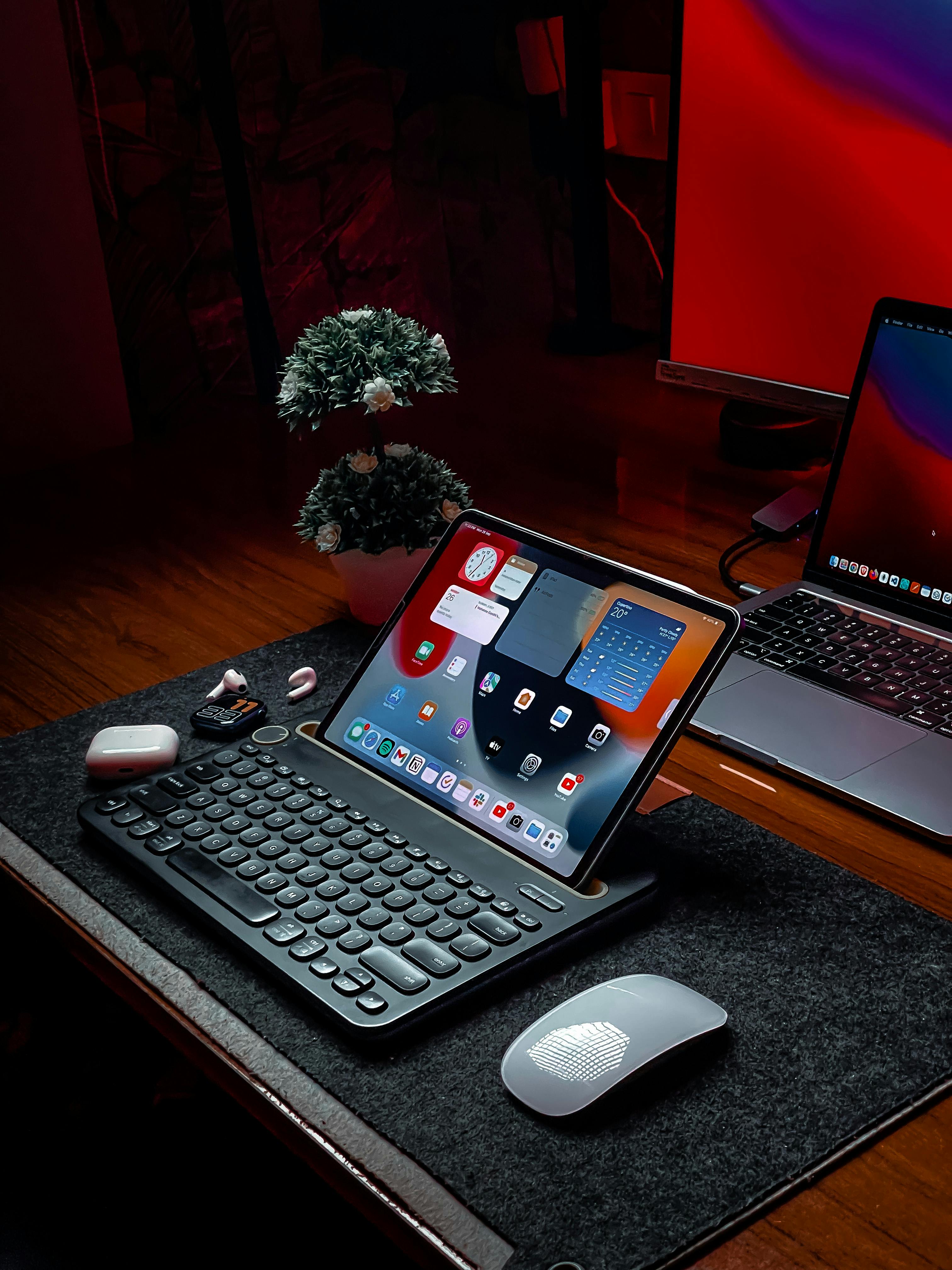 Three people sitting on a couch in a room looking at mobile devices