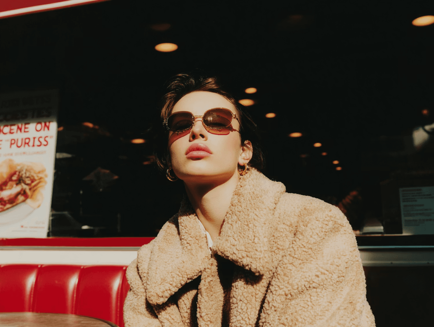 Stylish individual in a beige coat