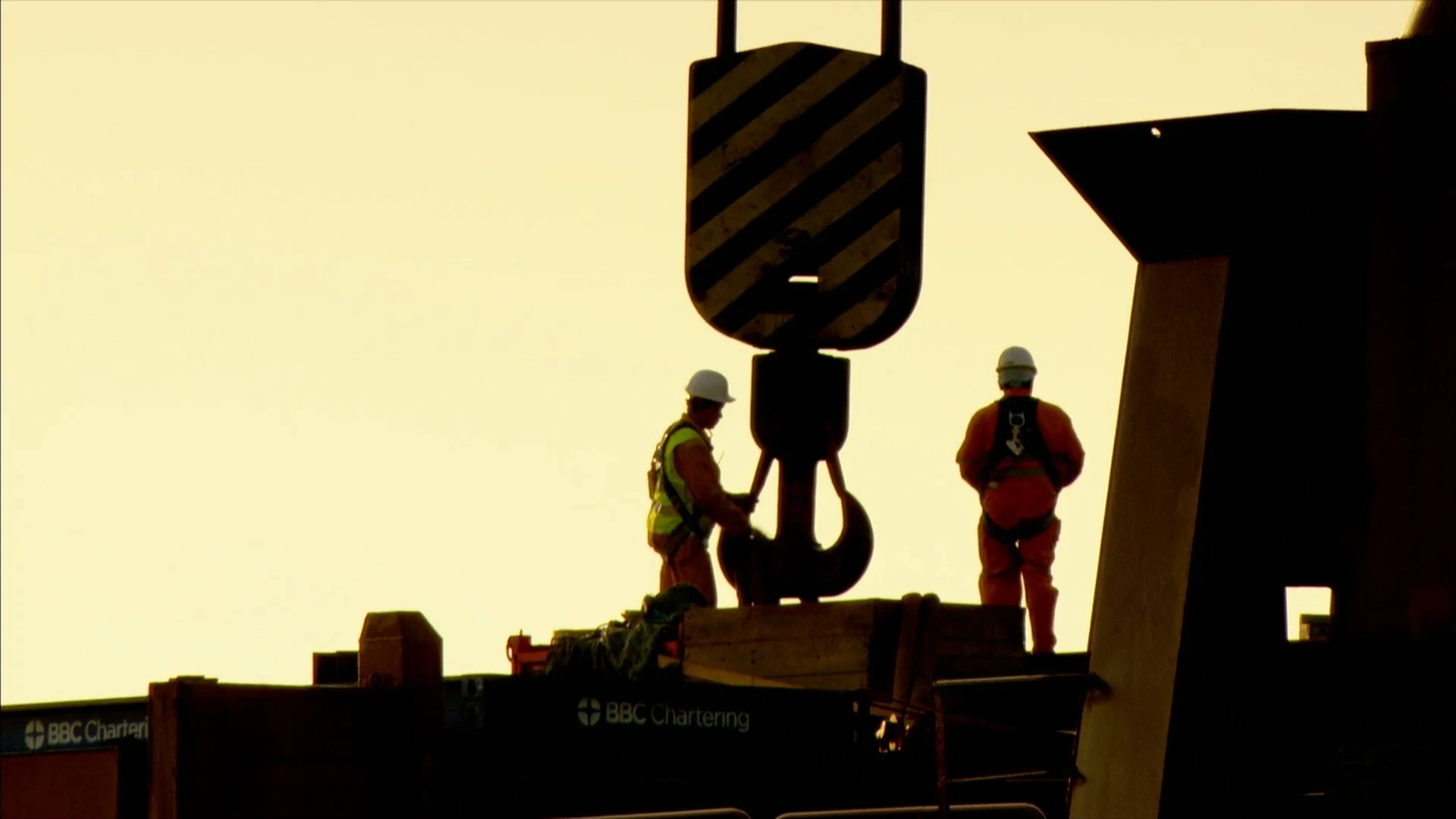 Crawler crane lifting a scaffold panel on site
