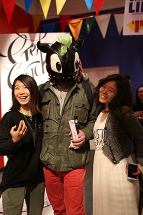 a person with a dragon hat and red pants