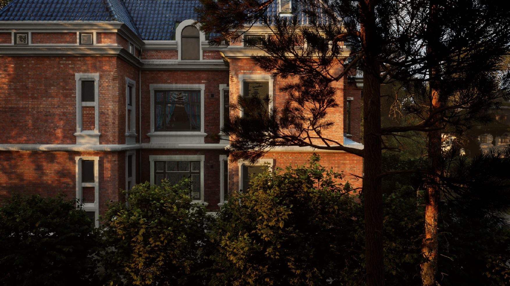 Side view of bushes and a brick house.
