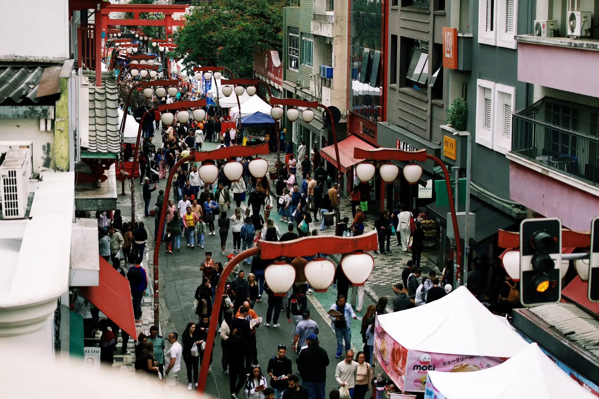 Vista do alto da rua com as lanternas e o torii da Liberdade, a partir de uma das varandas do Janela Viva