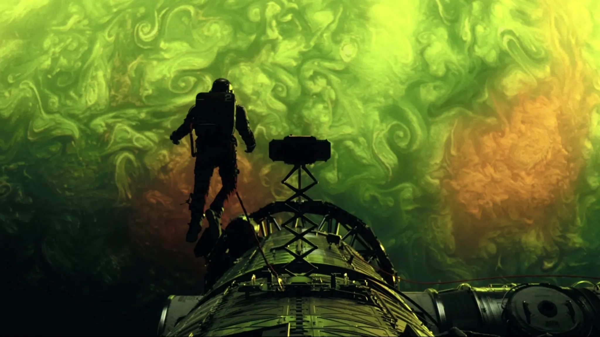 A lone astronaut in a spacesuit stands on the edge of a spacecraft, silhouetted against a swirling, colourful nebula of vibrant green and orange hues, creating a mesmerizing space exploration scene.
