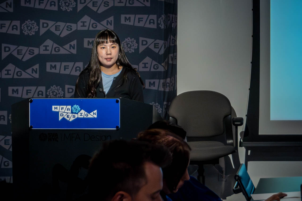 Woman at a podium delivering a presentation