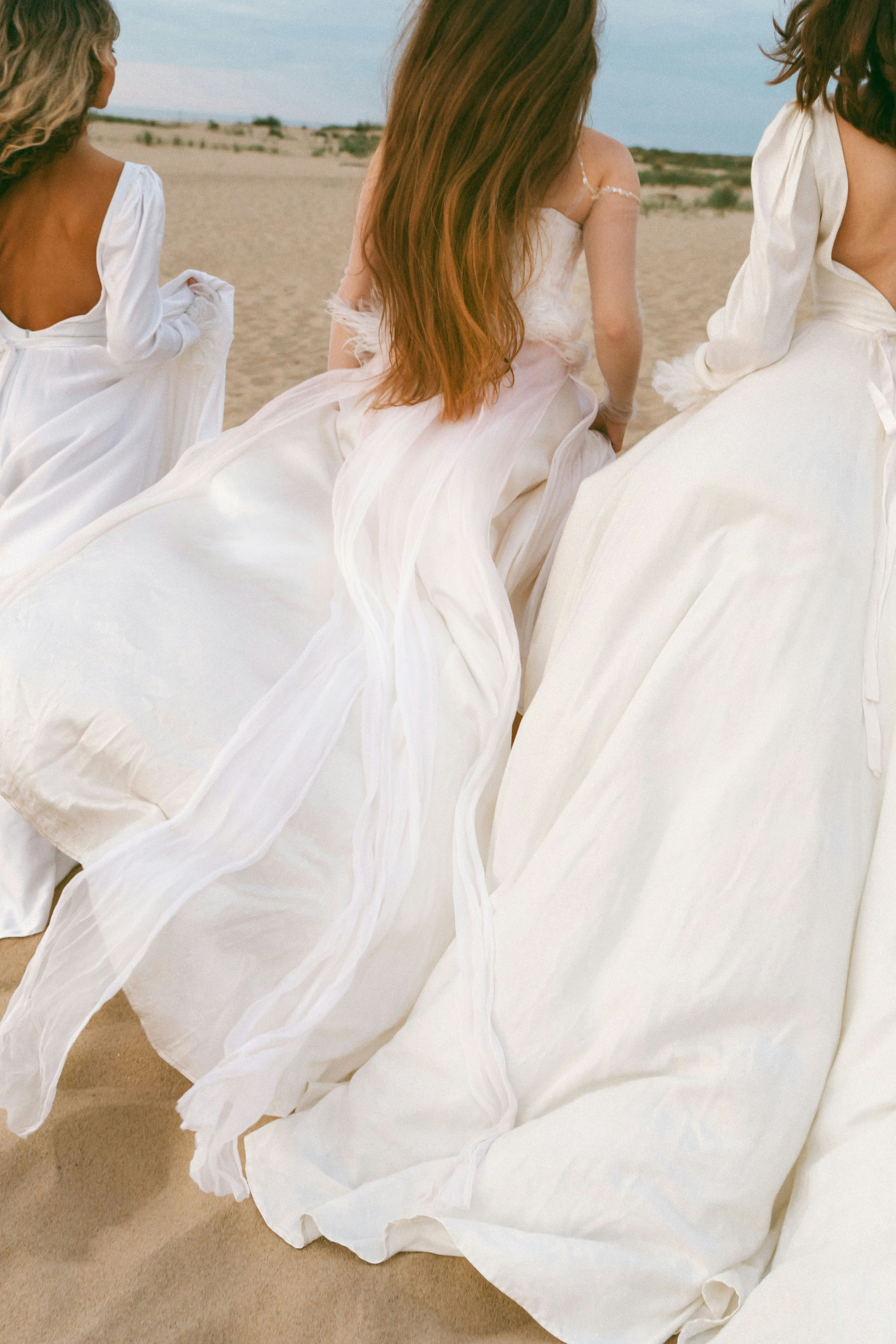 Women running with wedding dresses on