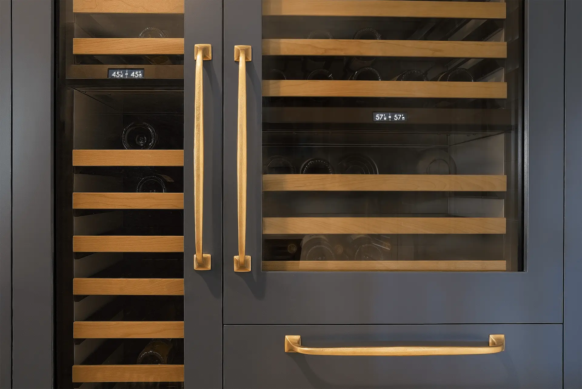 Close-up of the panel-ready wine fridge, a modern amenity that integrates seamlessly with the surrounding cabinetry in the Ladera Ranch Remodel. Photo by Todd Huge.