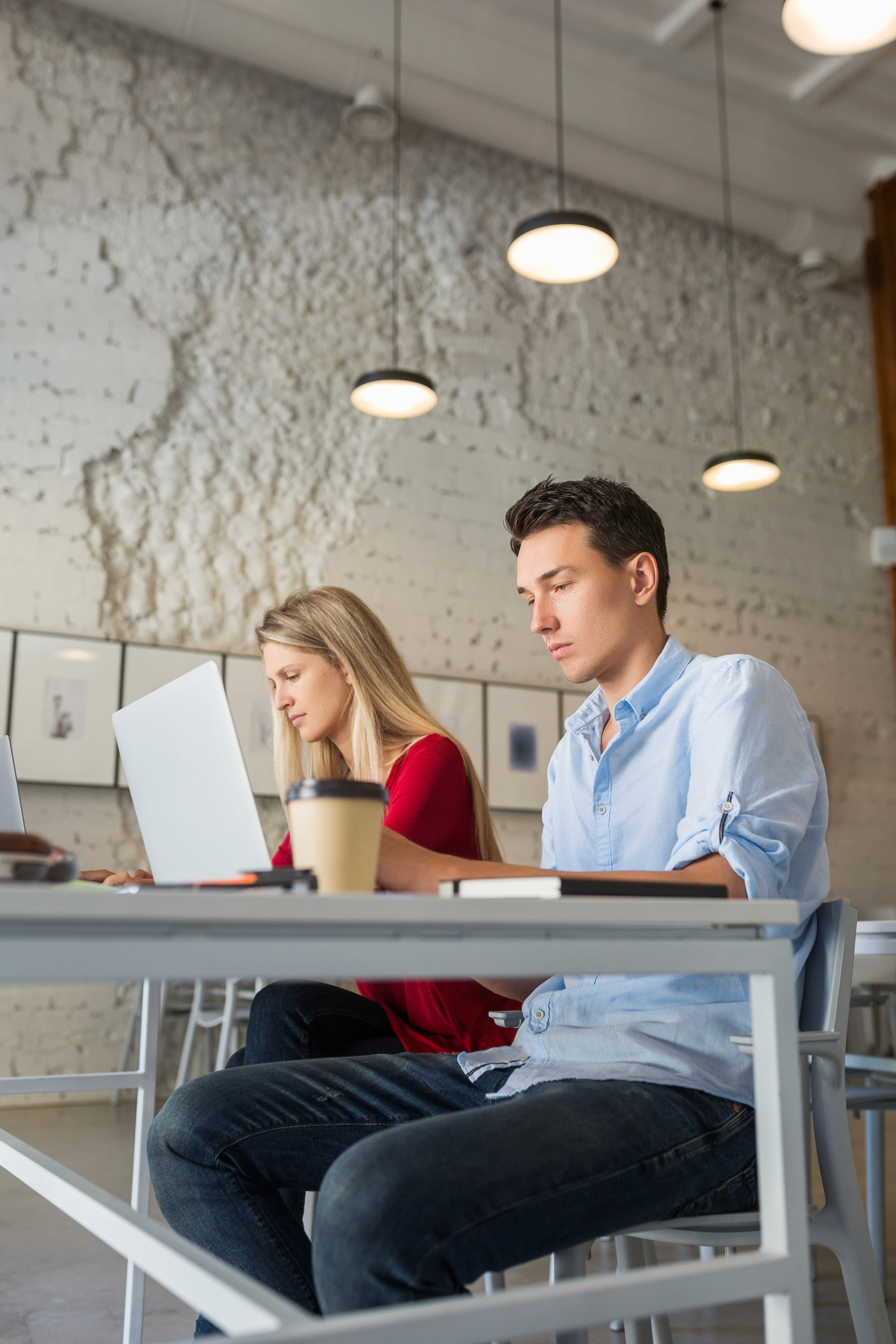 Two people working on laptops