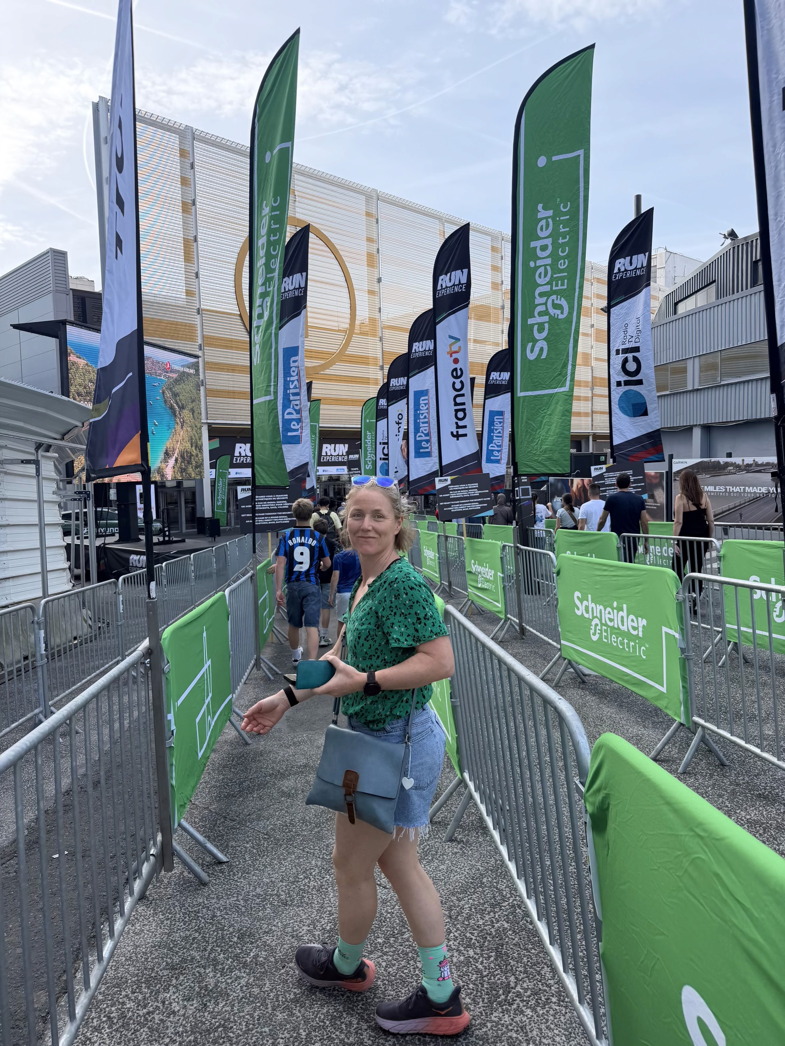 Caption: “Collecting the race pack. The smile hides what she already knew.”