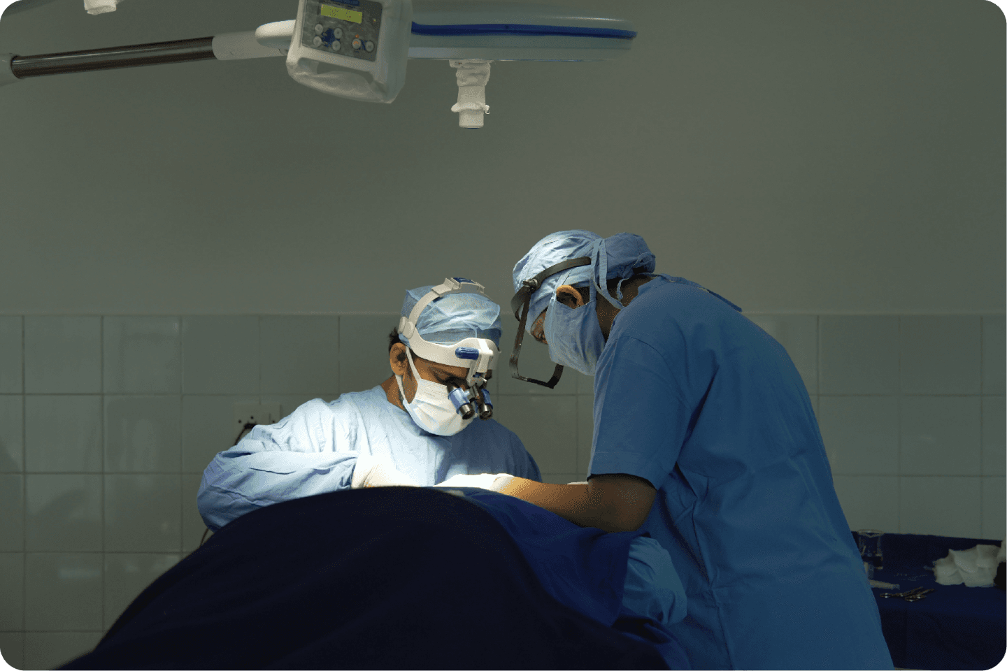 Smiling person with curly hair and closed eyes