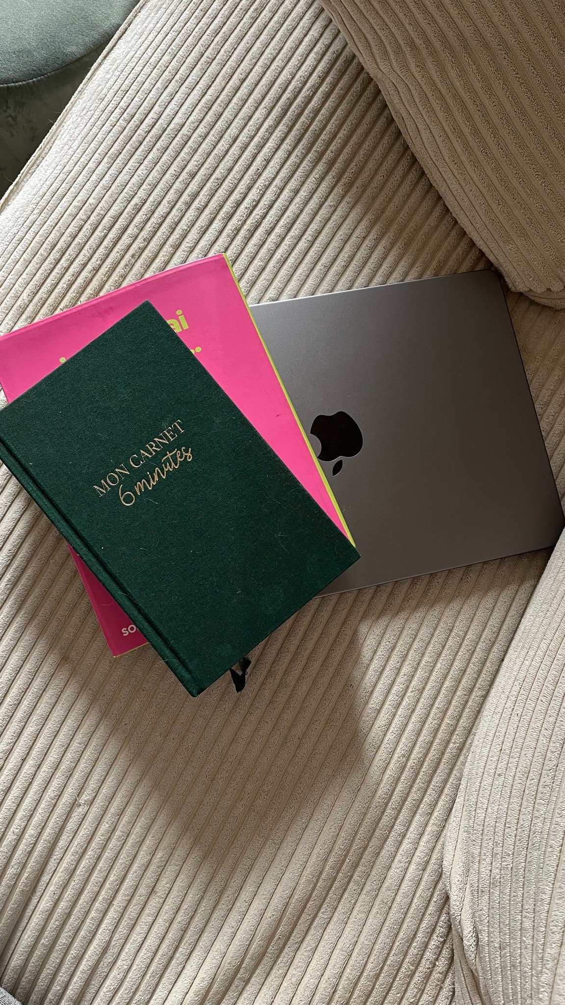 laptop with notebooks on top