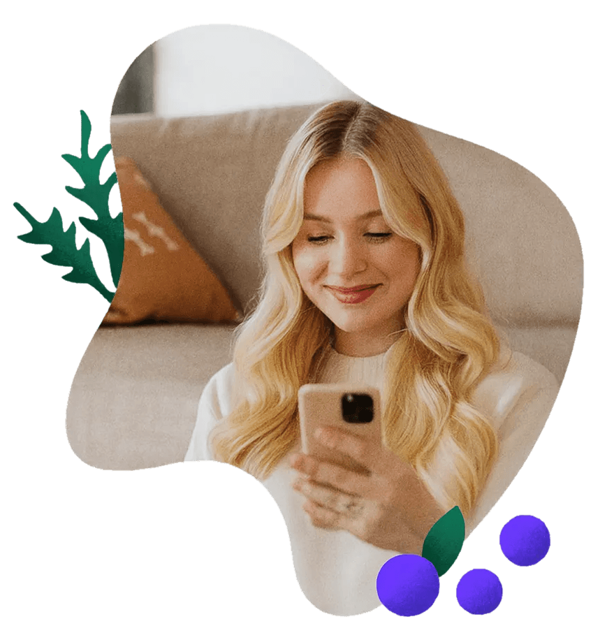 Woman smiling at her phone learning her nutrition therapy is covered by insurance