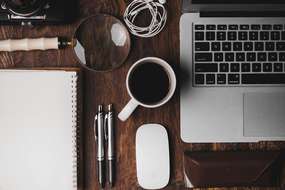 A creative studio desk with laptop and coffee.