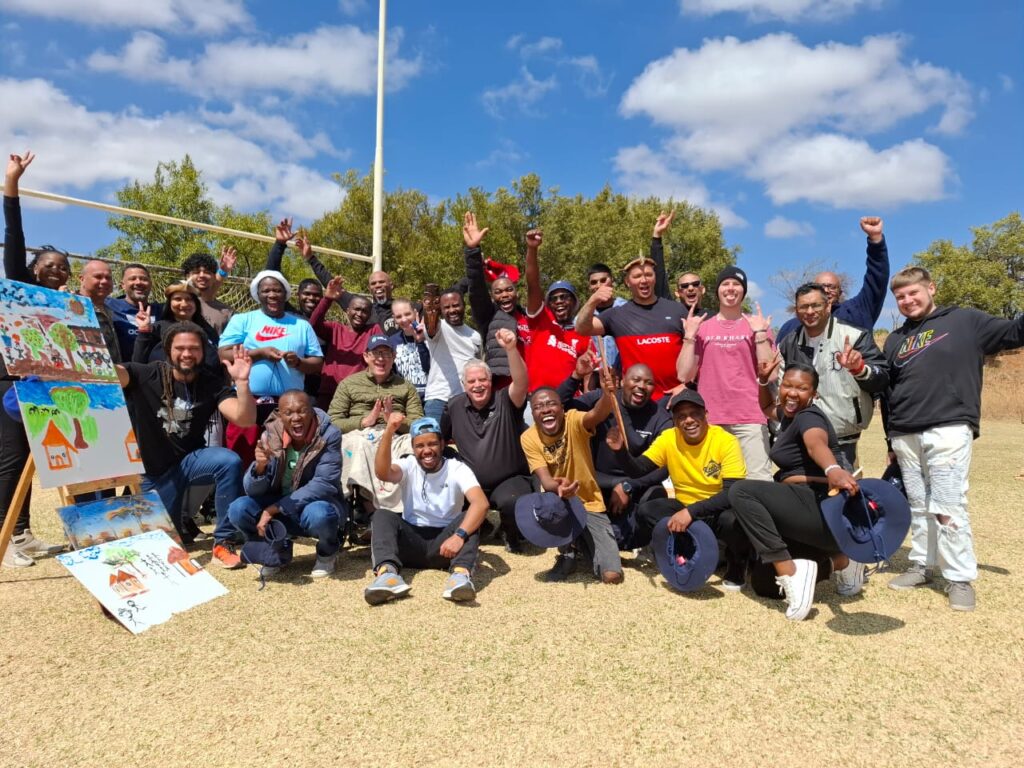 group of women in red and white dress standing on brown wooden bar during daytime