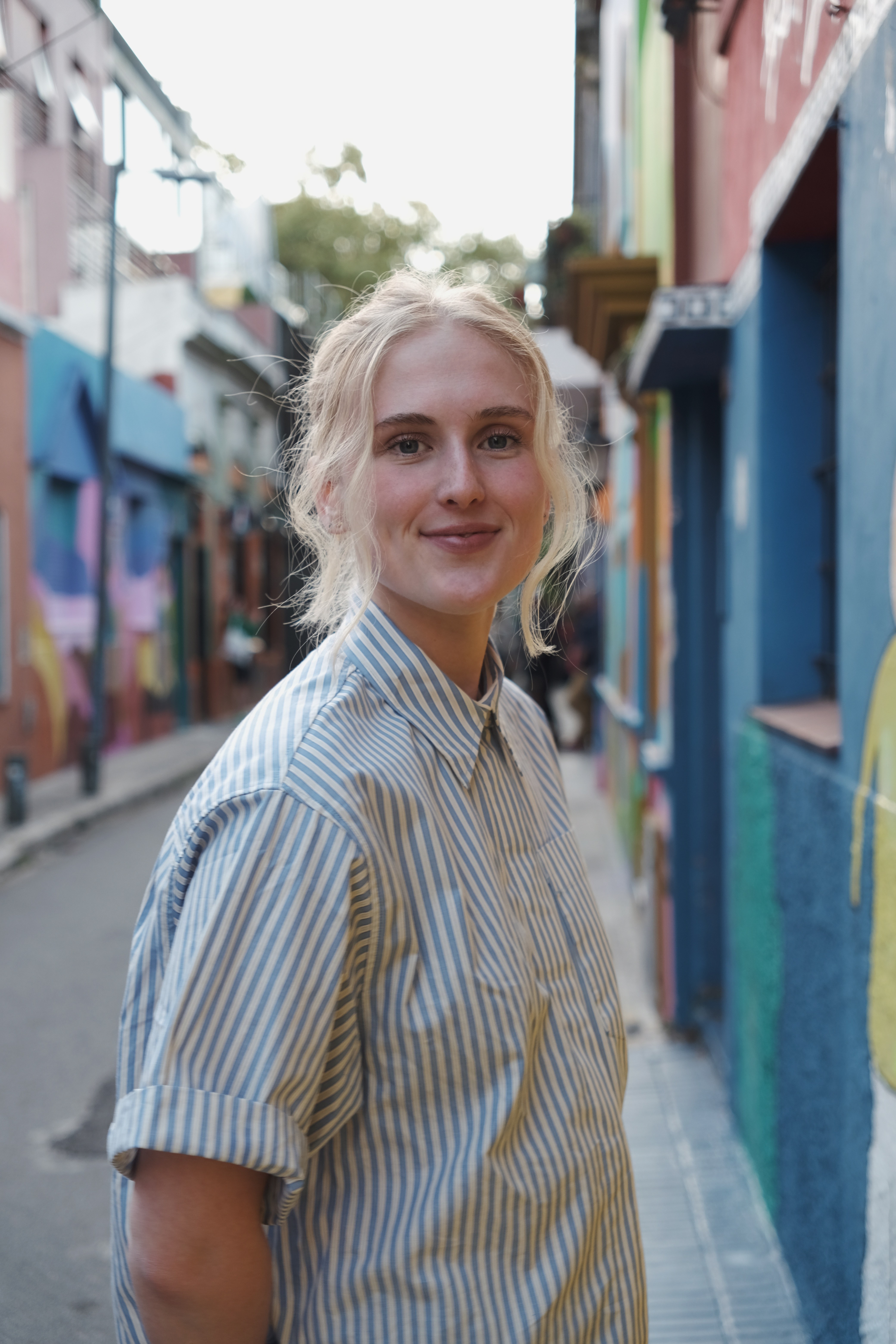 Close-up of a hand holding a smartphone with a matte dark case and a minimalist finger grip accessory